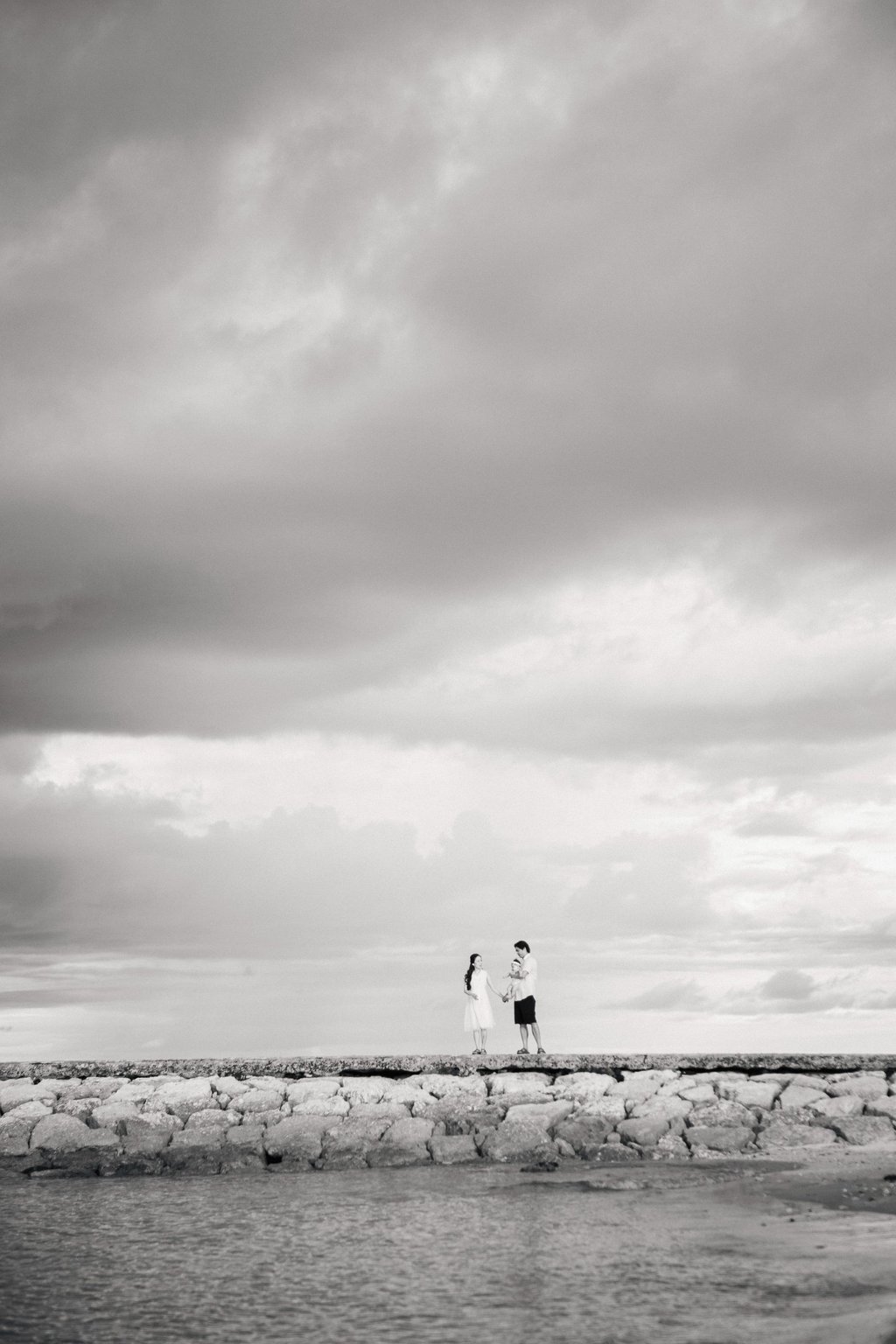 Couple walking along the beach during family photography session at Sofitel Nusa Dua Bali