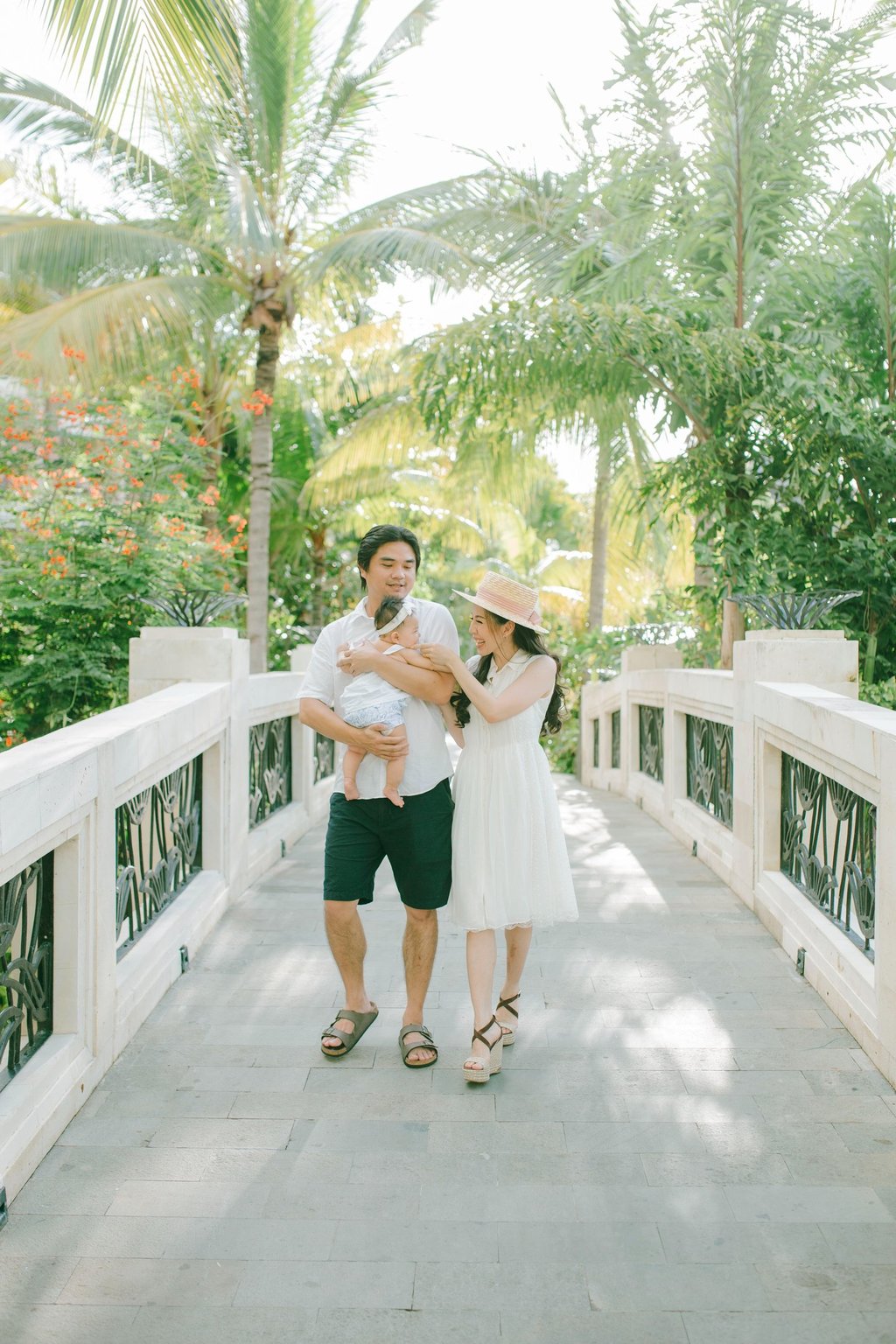 xFamily walking on resort bridge during Sofitel Nusa Dua Bali family photography session