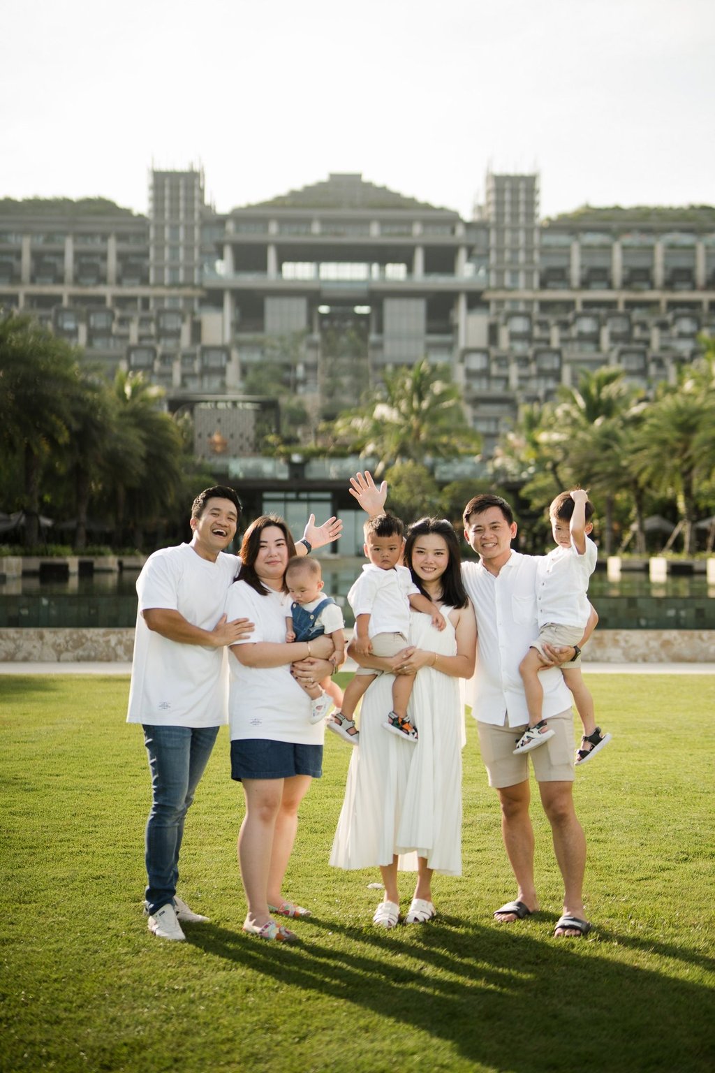Family portrait with The Apurva Kempinski resort building in the background in Nusa Dua Bali