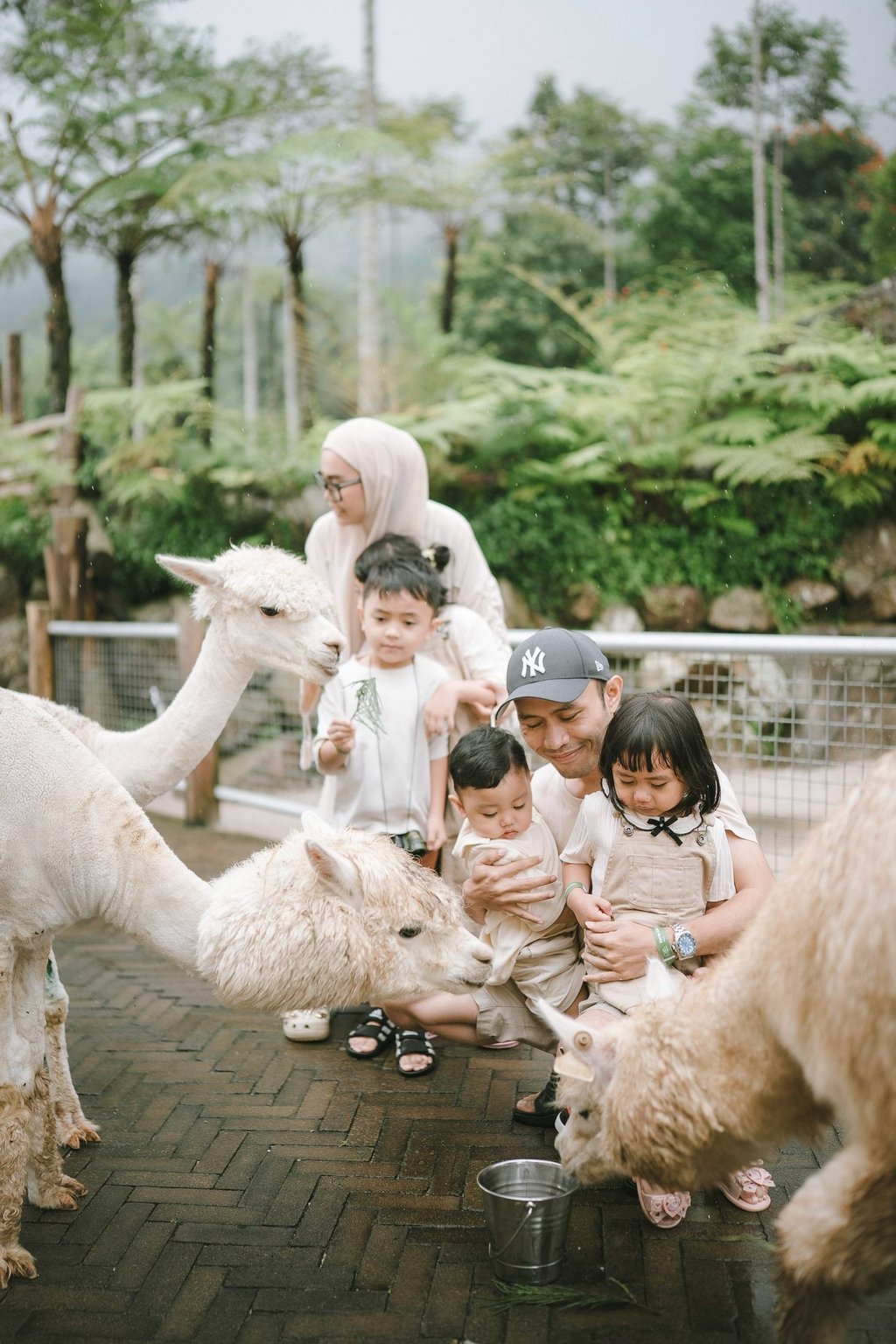 Family with alpaca during a family photography session at Bali Farm House Bedugul Bali.