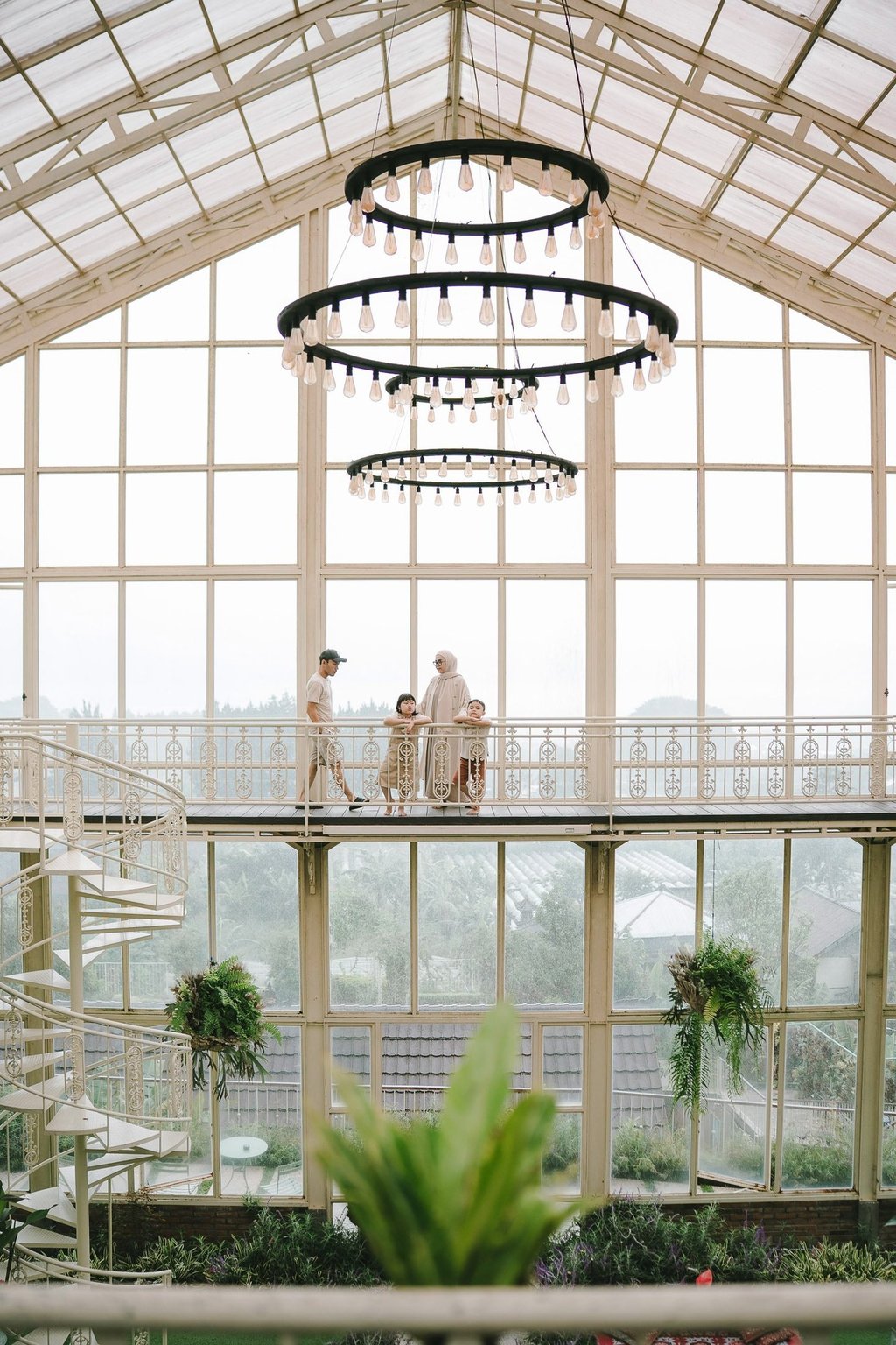 Family walking in rain during a family photography session at Rumah Gemuk Bedugul Bali.