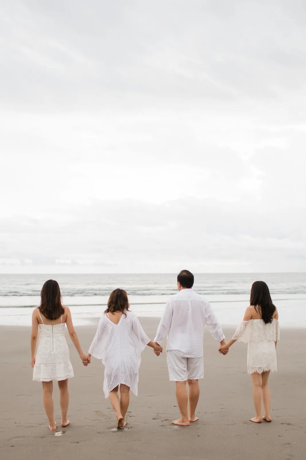 Janice family walking along the beach during a calm family photography session at Indigo Seminyak Bali