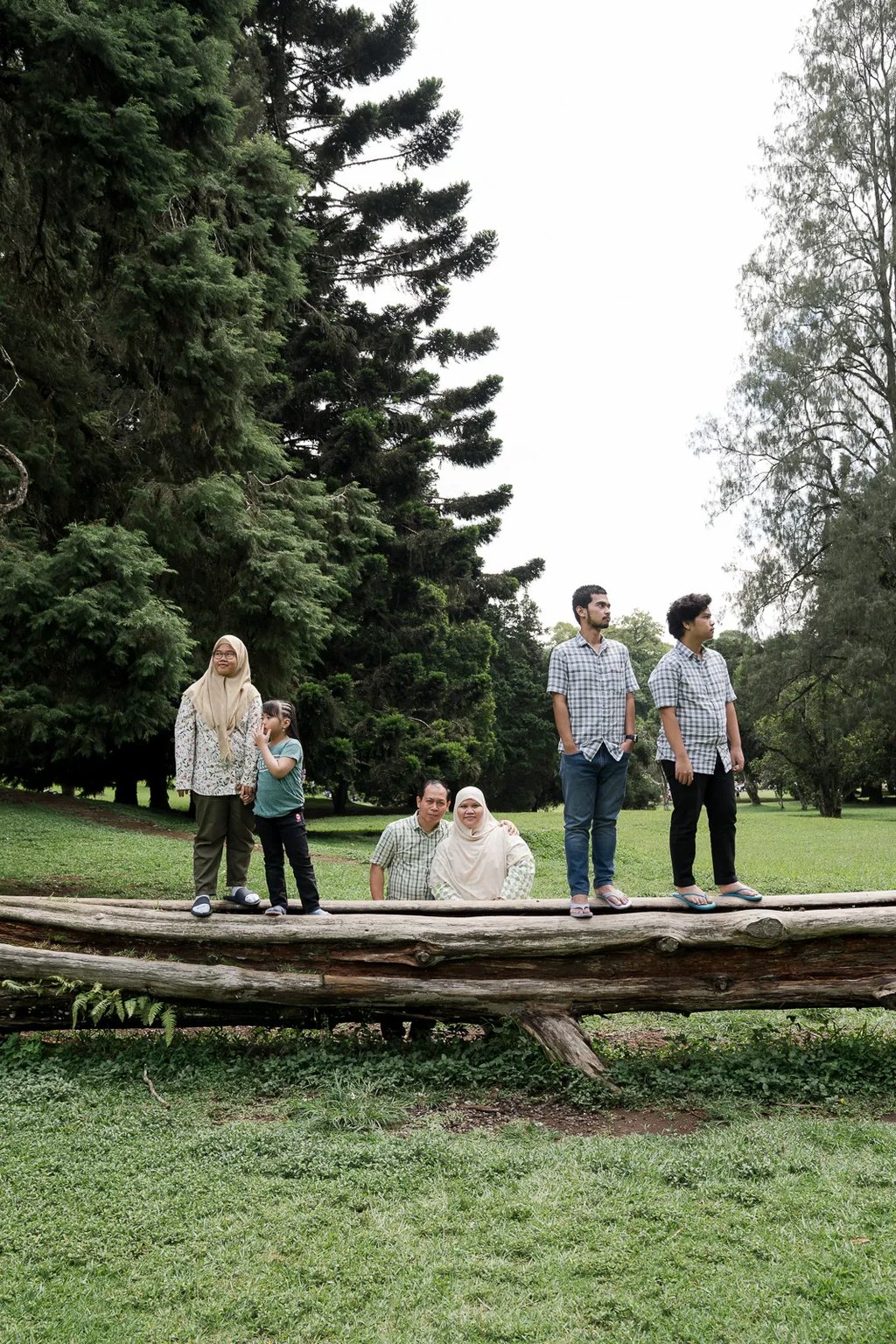 Iqbal family walking together during an outdoor family photography session at Botanical Garden Bedugul.