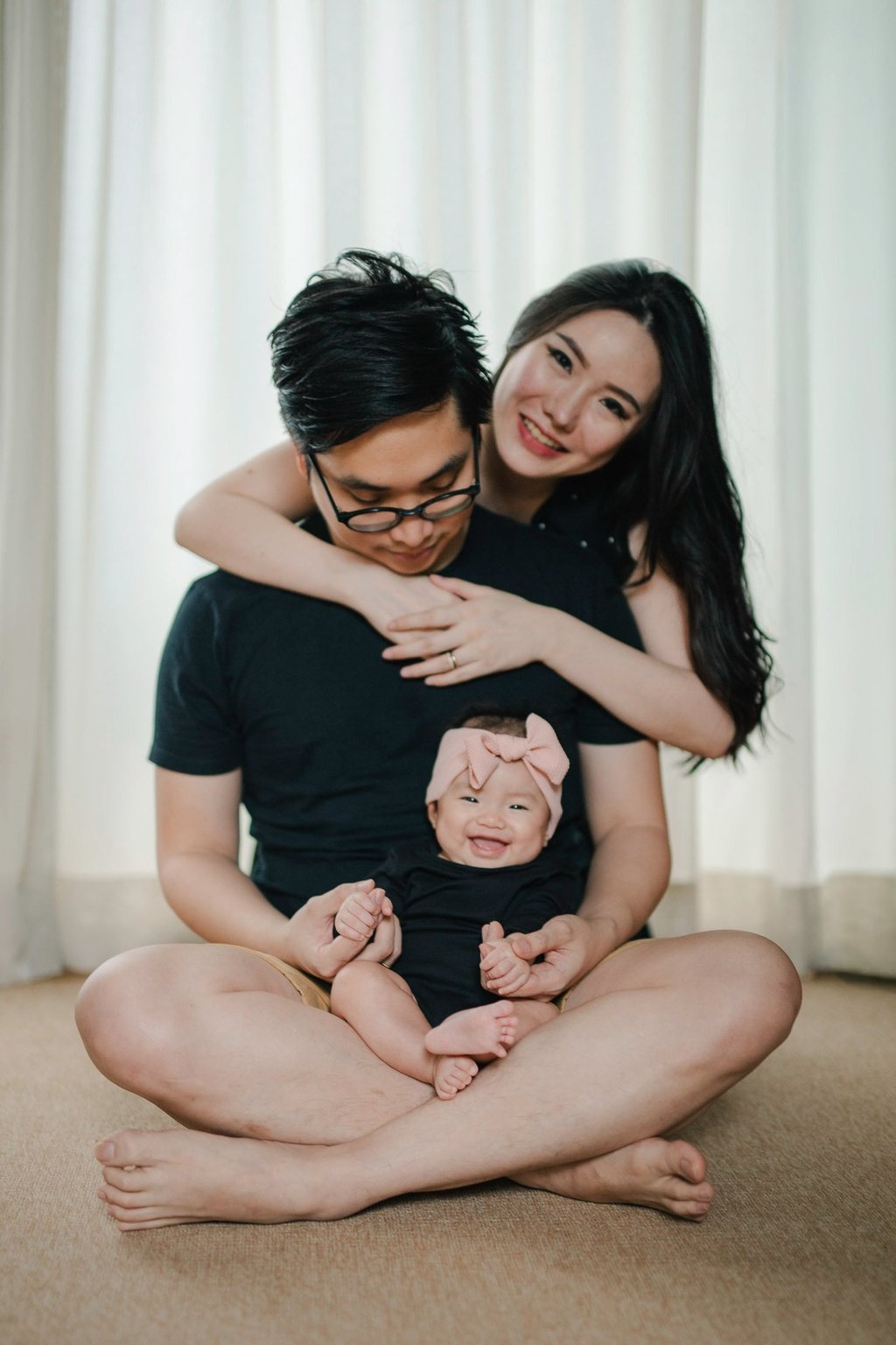 Family seated on sofa during a family photography session at a private villa in Ubud Bali.