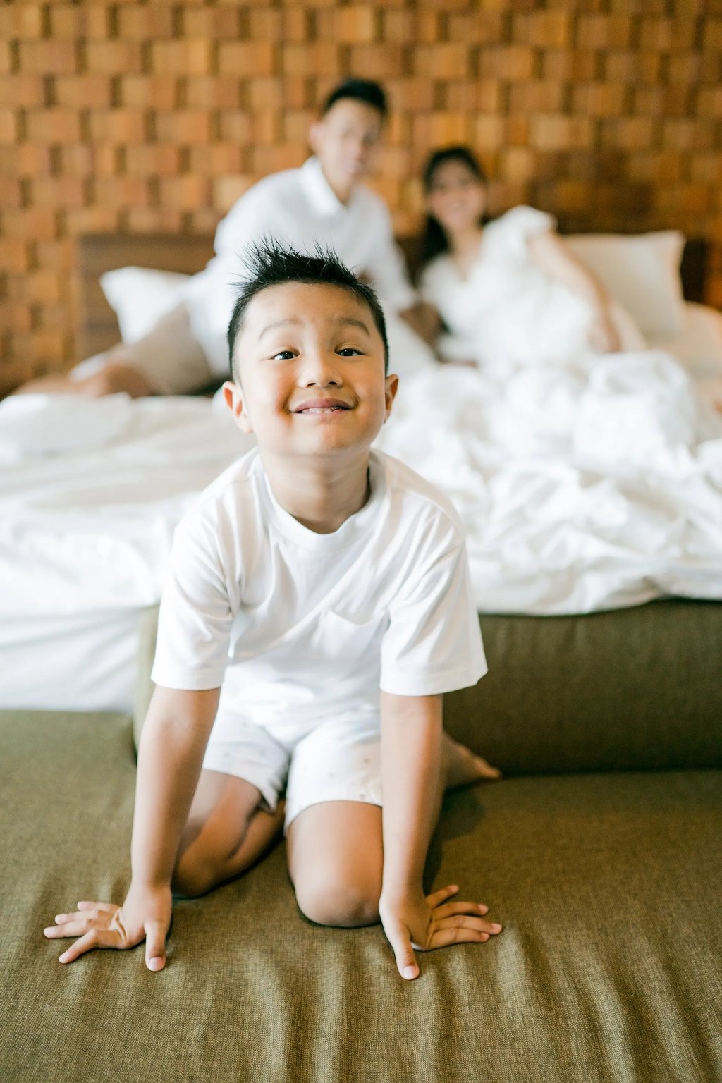 Child smiling during a playful family photography session at Anantara Uluwatu Bali.