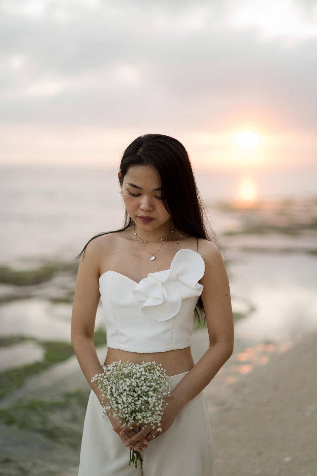 Bride portrait at sunset near ocean waves at Melasti Beach Bali