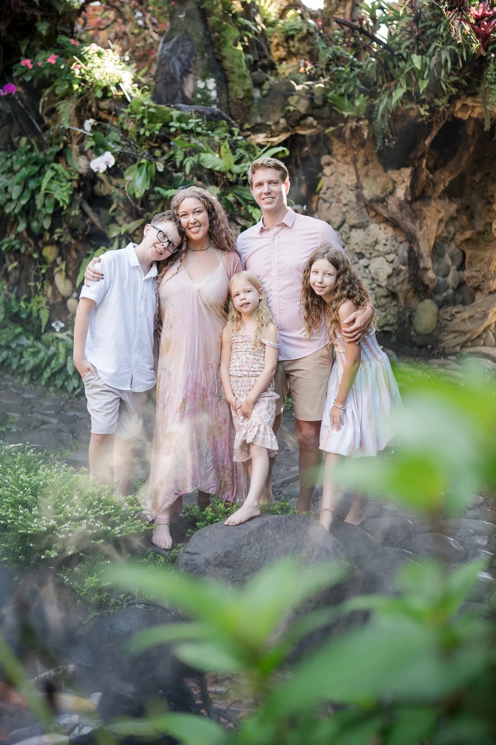 Family portrait surrounded by tropical plants at Umbul Sari Water Garden in Ubud Bali