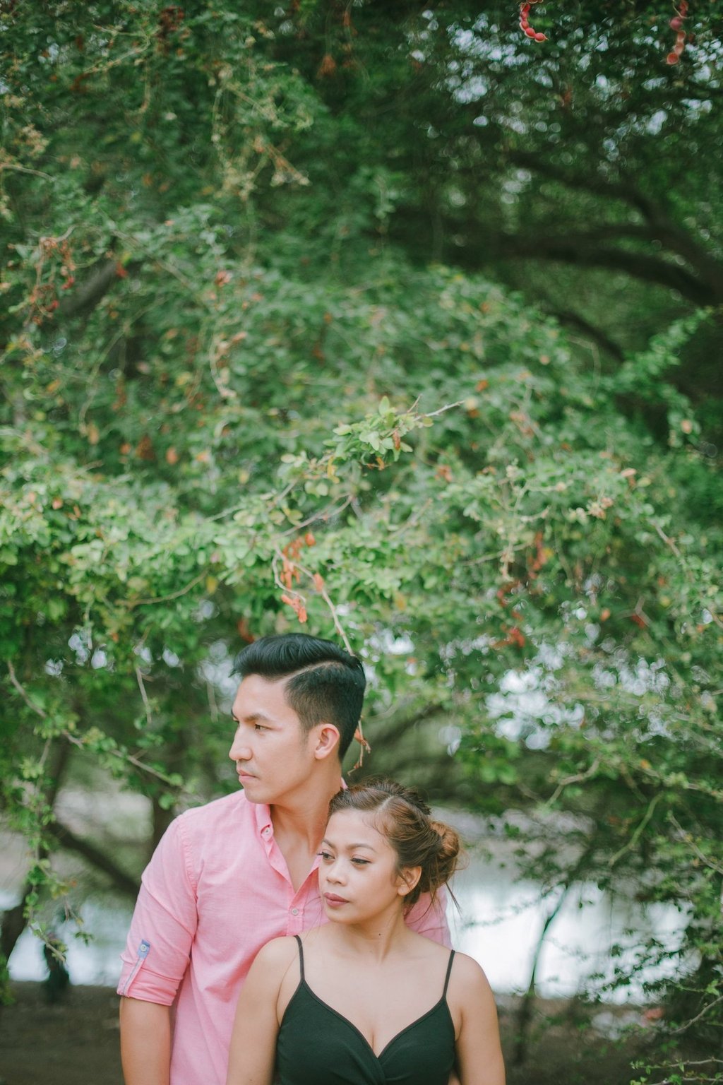 Romantic couple portrait under green trees at Serangan Benoa Bali.