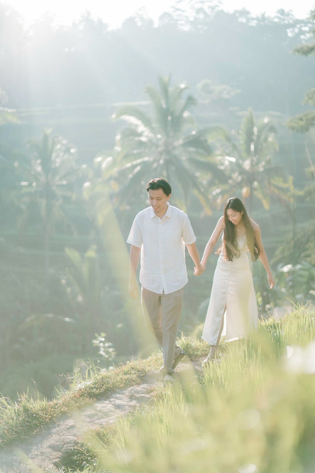 Backlit intimate couple embrace during a sunrise photography session at Tegalalang Ubud Bali.