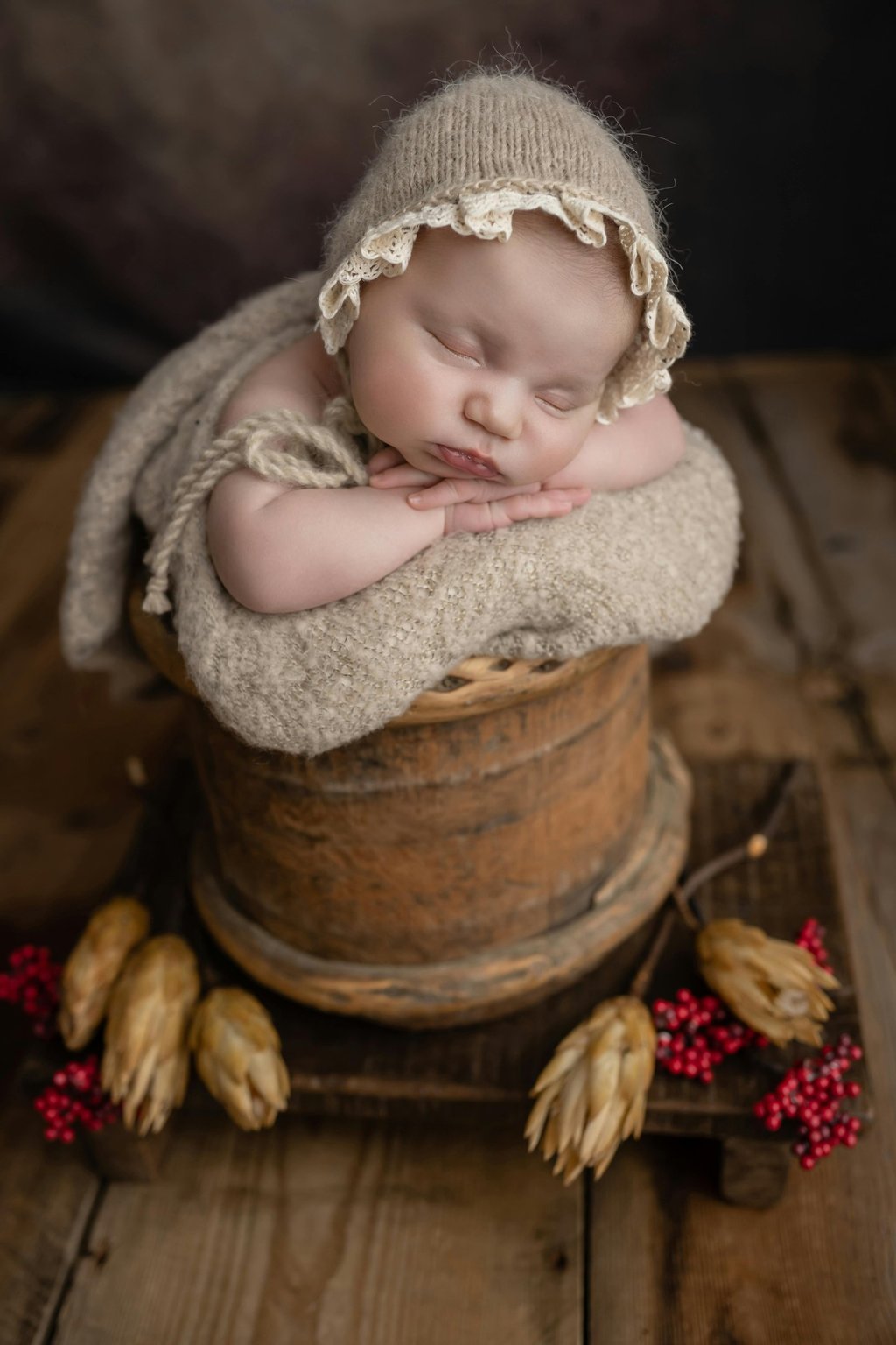 a baby in a basket with a hat on