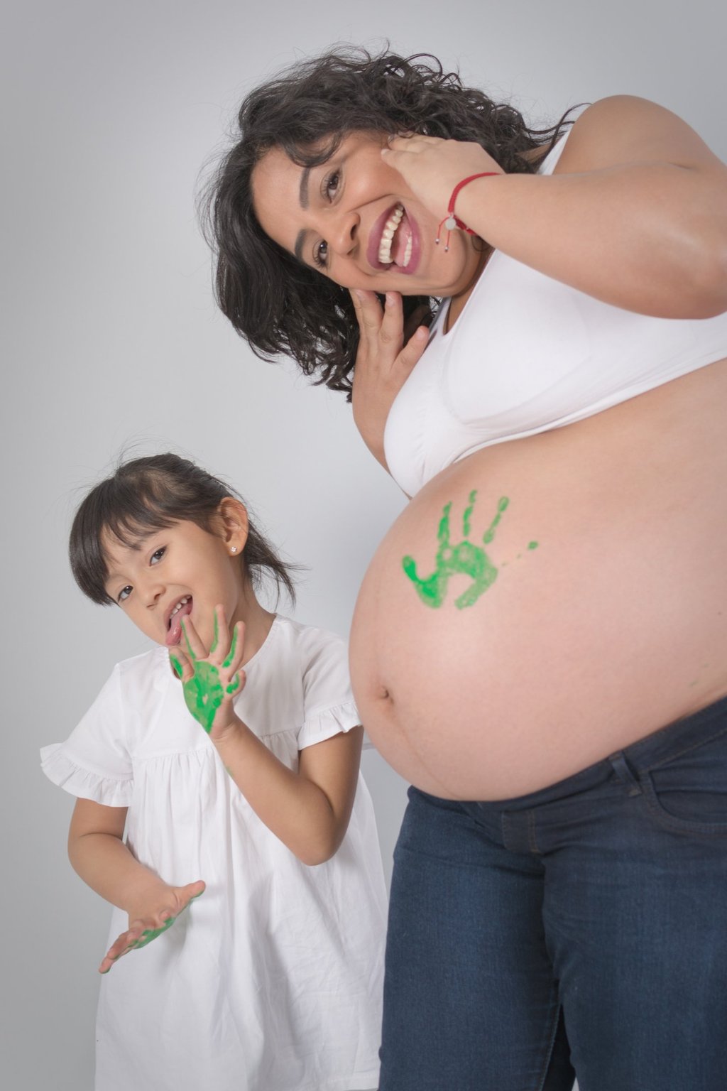 a pregnant woman with a baby bump bumping her belly