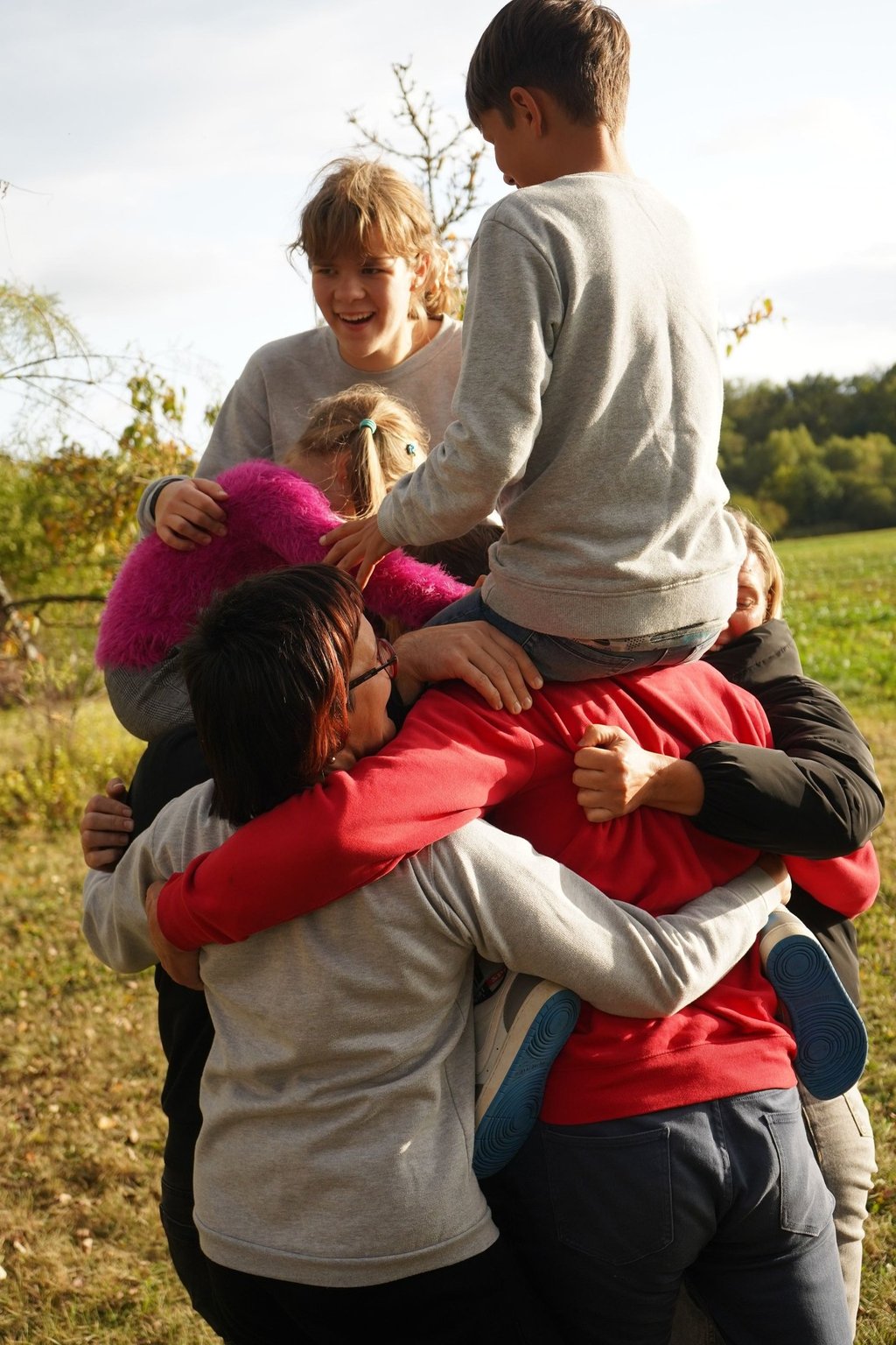 Džiaugsmingi apsikabinimai su bendruomenės nariais