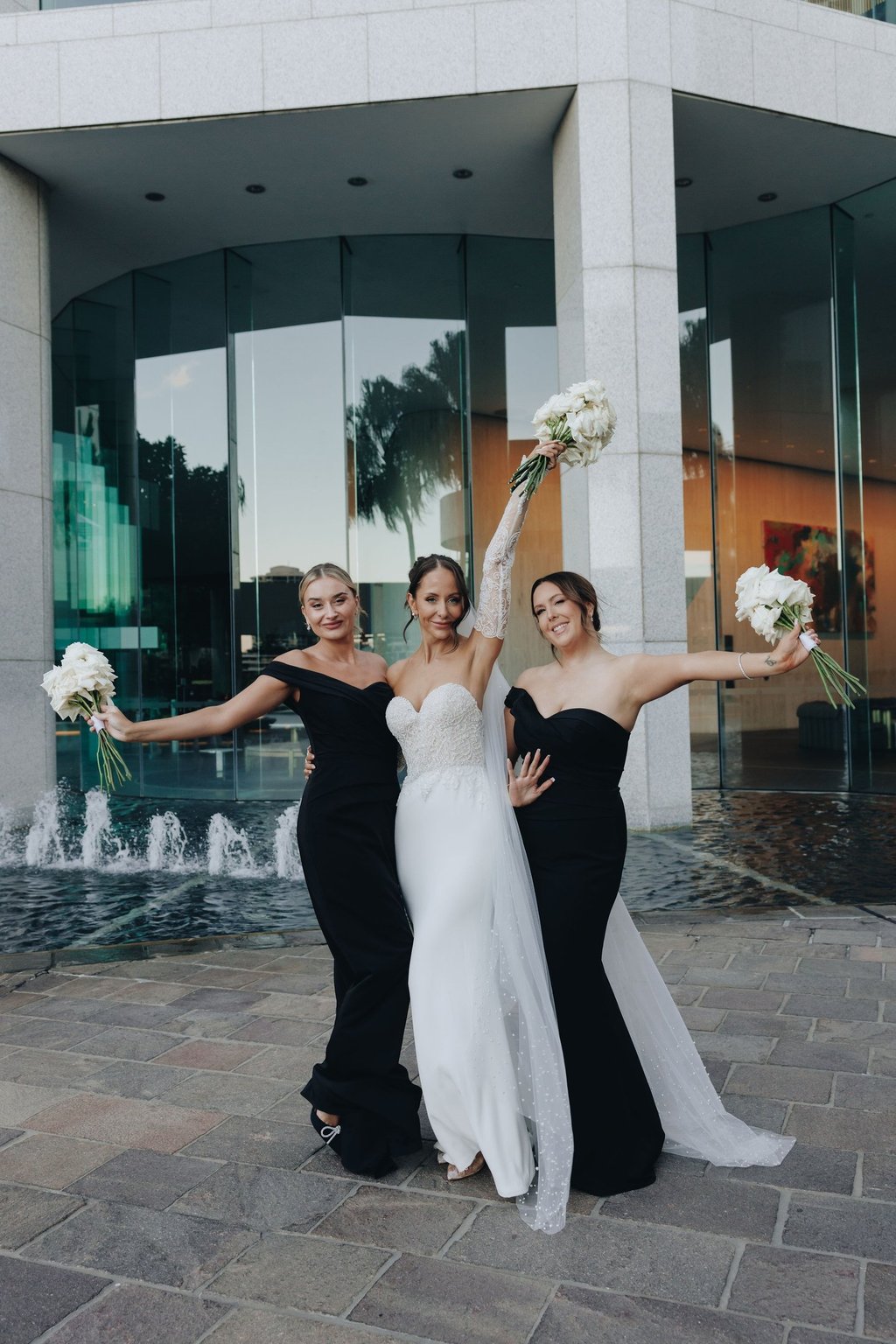 a bride and bridesmaid posing for a photo