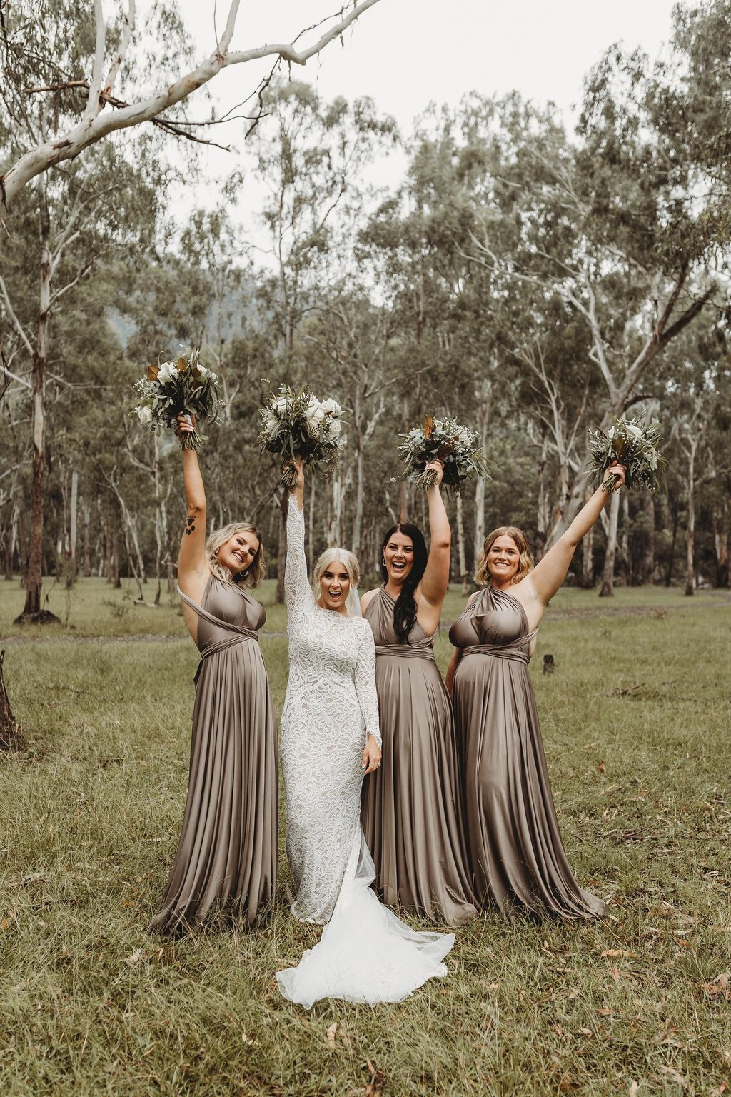 a bride and her bridesmaid posing for a photo