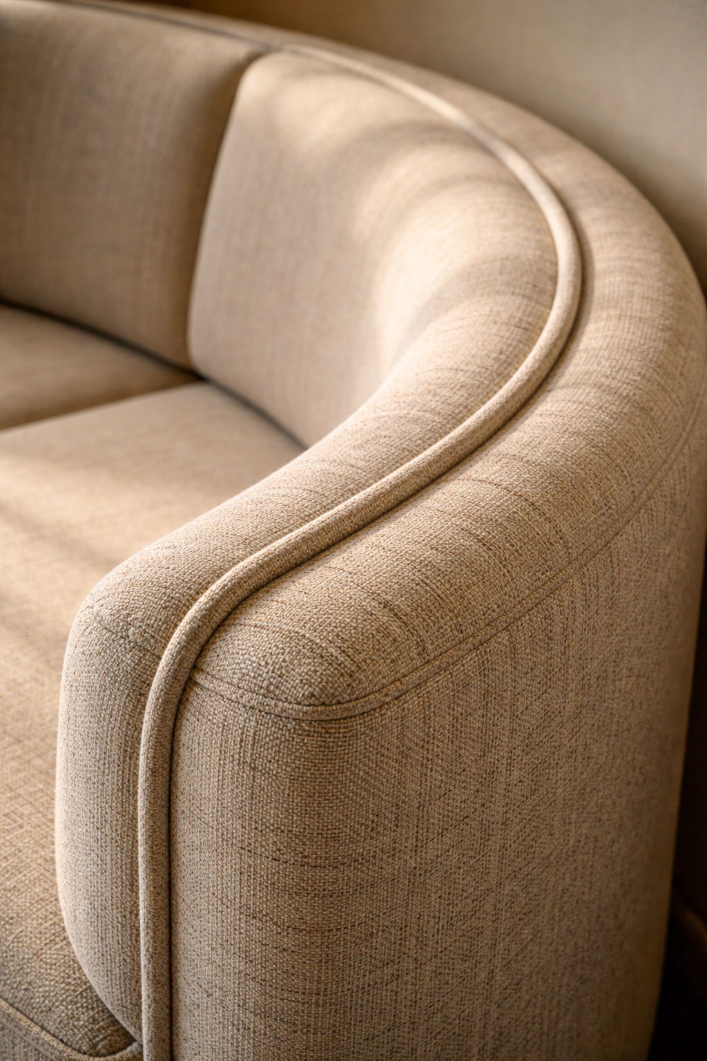 Close-up detail of a custom made banquette showing curved radius, stitching, and upholstery texture