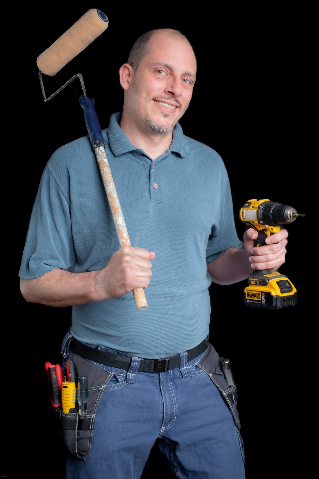 Portrait of Cyd holding a paint roller and a drill
