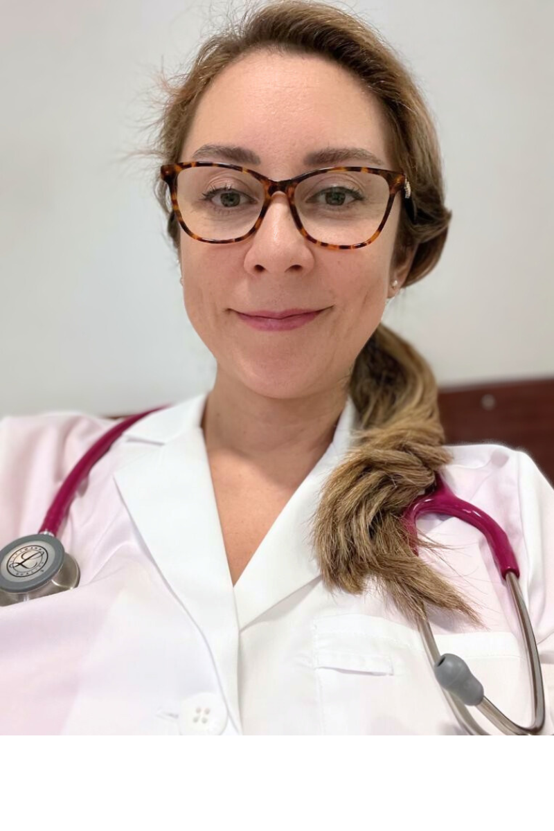 a woman in a white lab coat and glasses