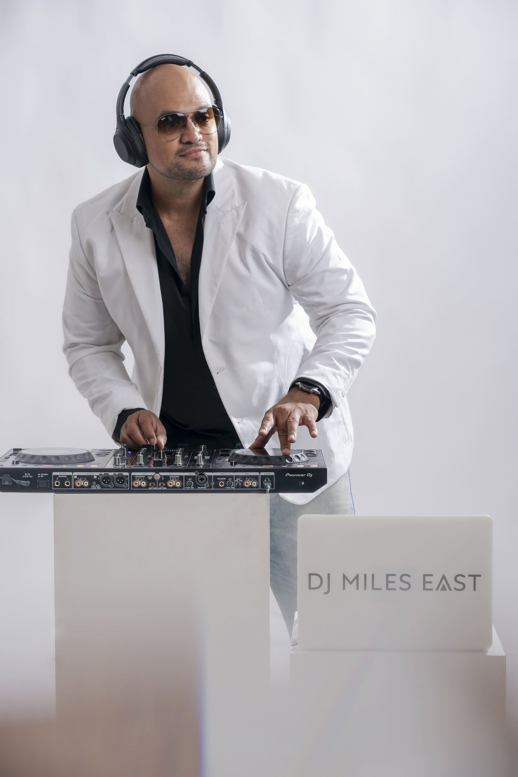 a dj in a white jacket and headphones