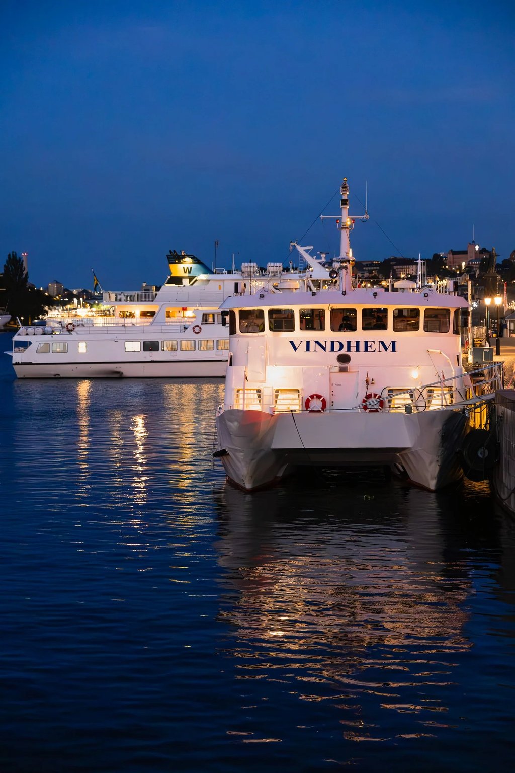 a boat in the water with a boat in the background