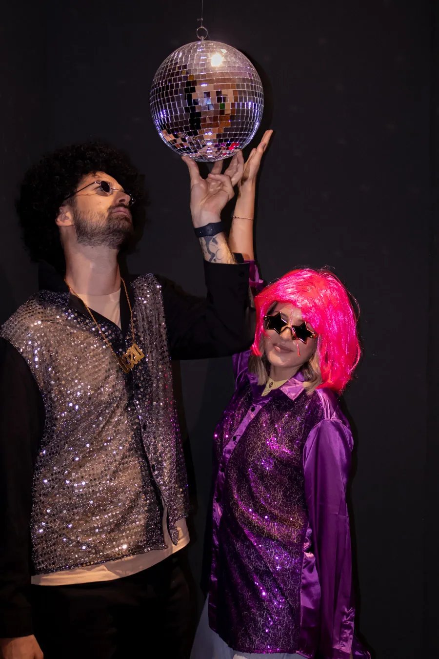 Tourists holding a disco ball in a neon-lit party room, a unique things to do in Split nightlife.