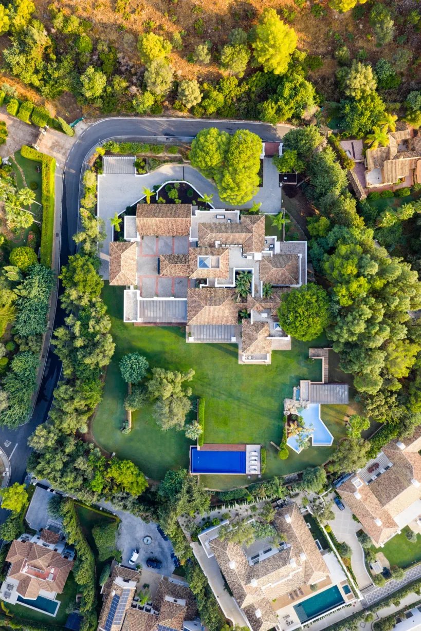 Aerial view of hillside estate with expansive gardens