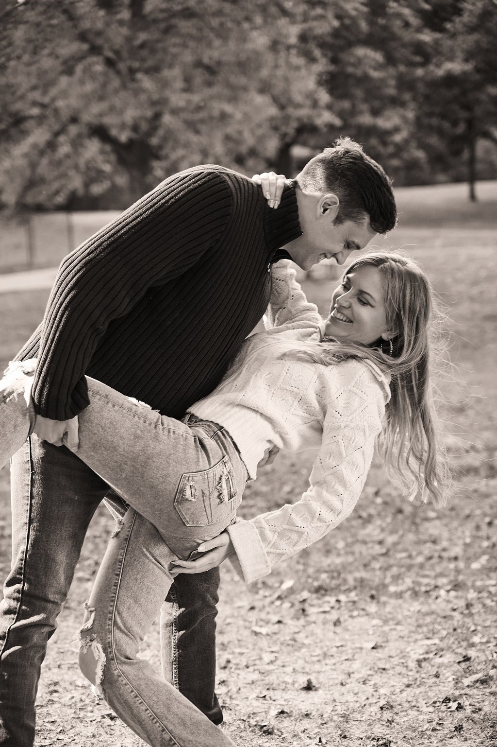 a man holding a woman and bending down to kiss her