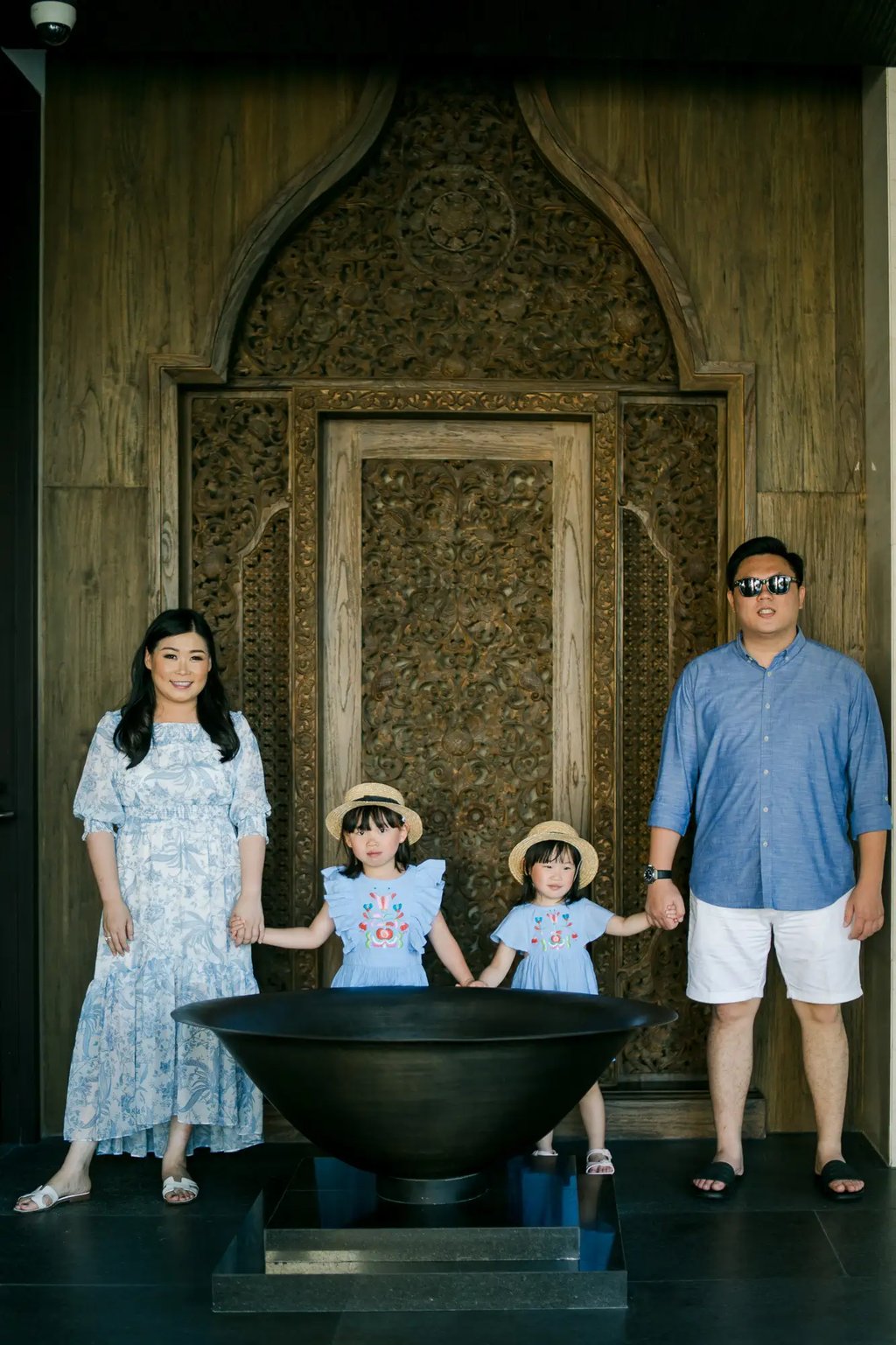 Family standing beneath the iconic Grand Lobby at The Apurva Kempinski Bali