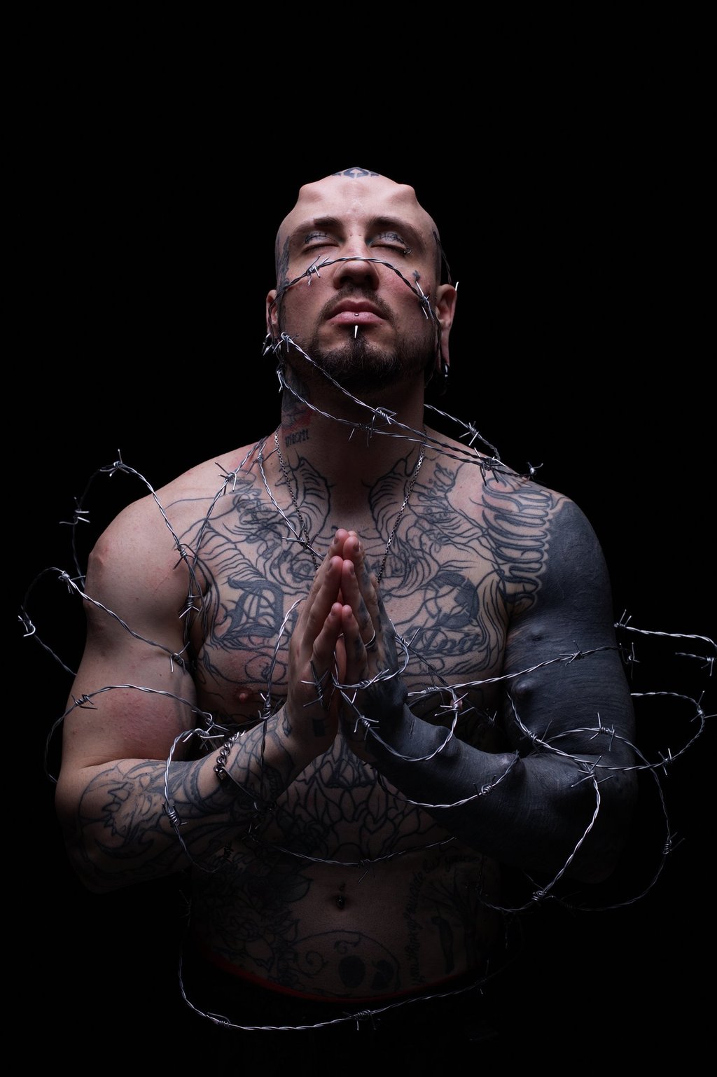 a man with tattoos on his chest and arms