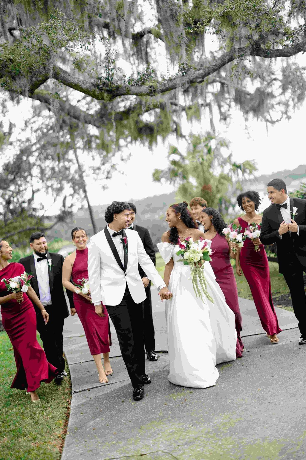 couple at lakeview gardens with bridesmaids in burgundy