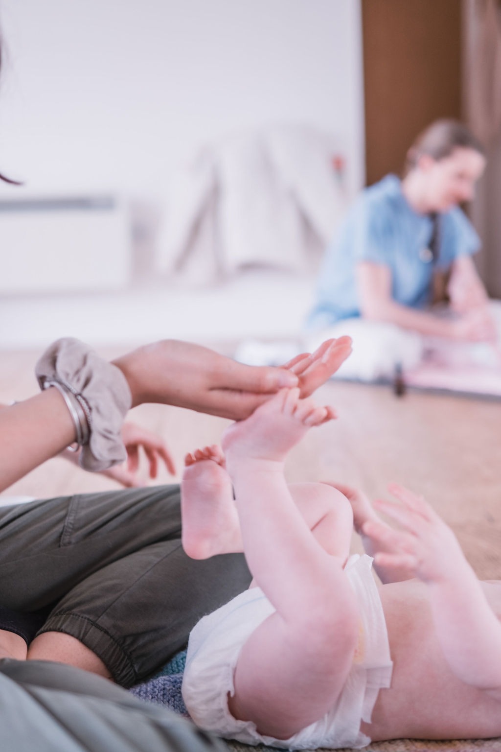 Parent and baby taking part in a gentle baby yoga class at Radwinter Pavilion near Saffron Walden