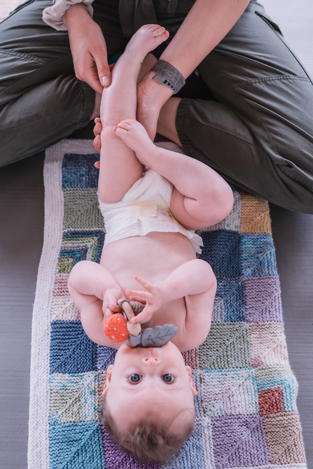 Baby stretching with parent during Rock & Roll Baby yoga in Radwinter near Saffron Walden