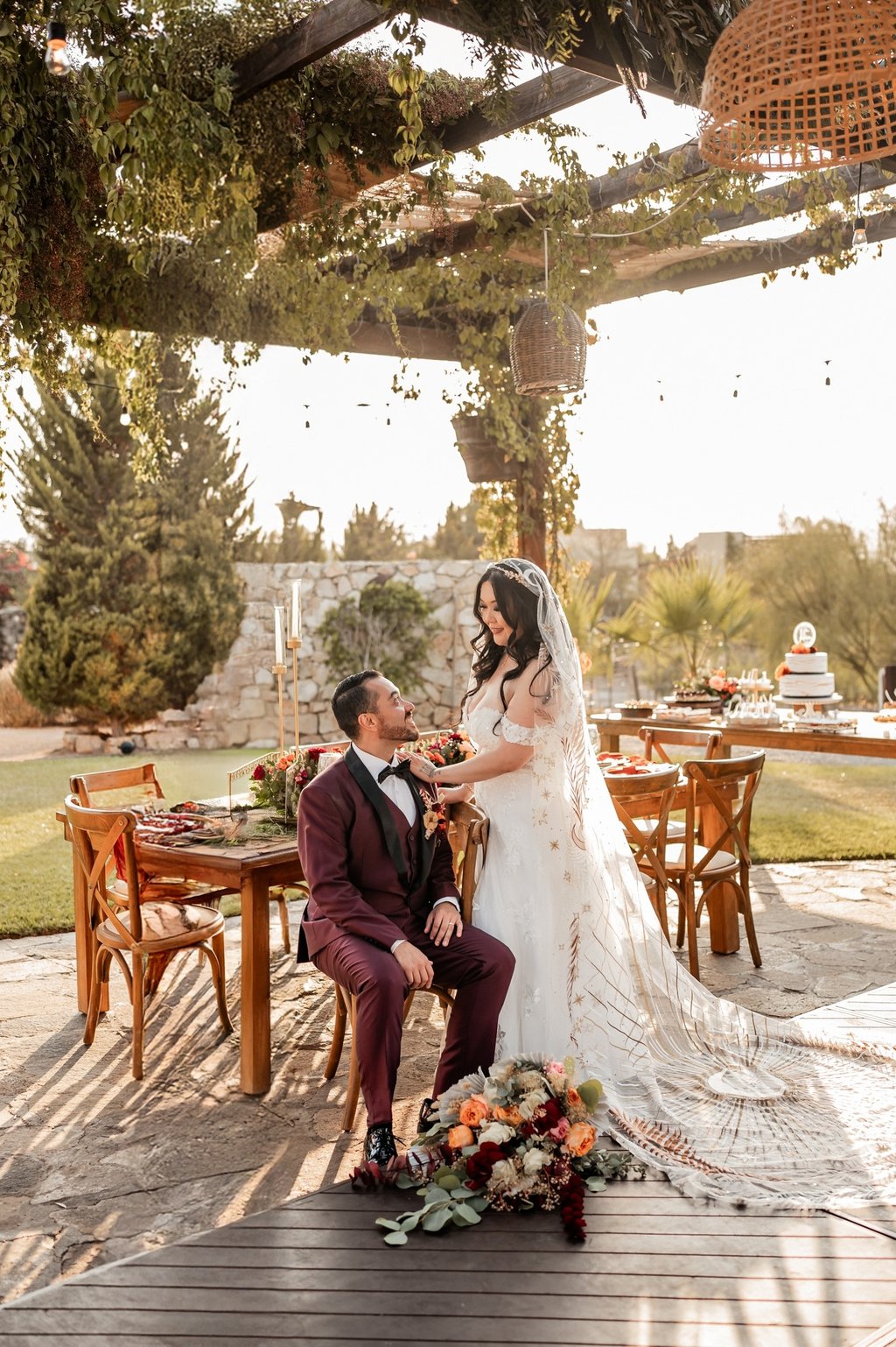a bride and groom sitting on a deck deck