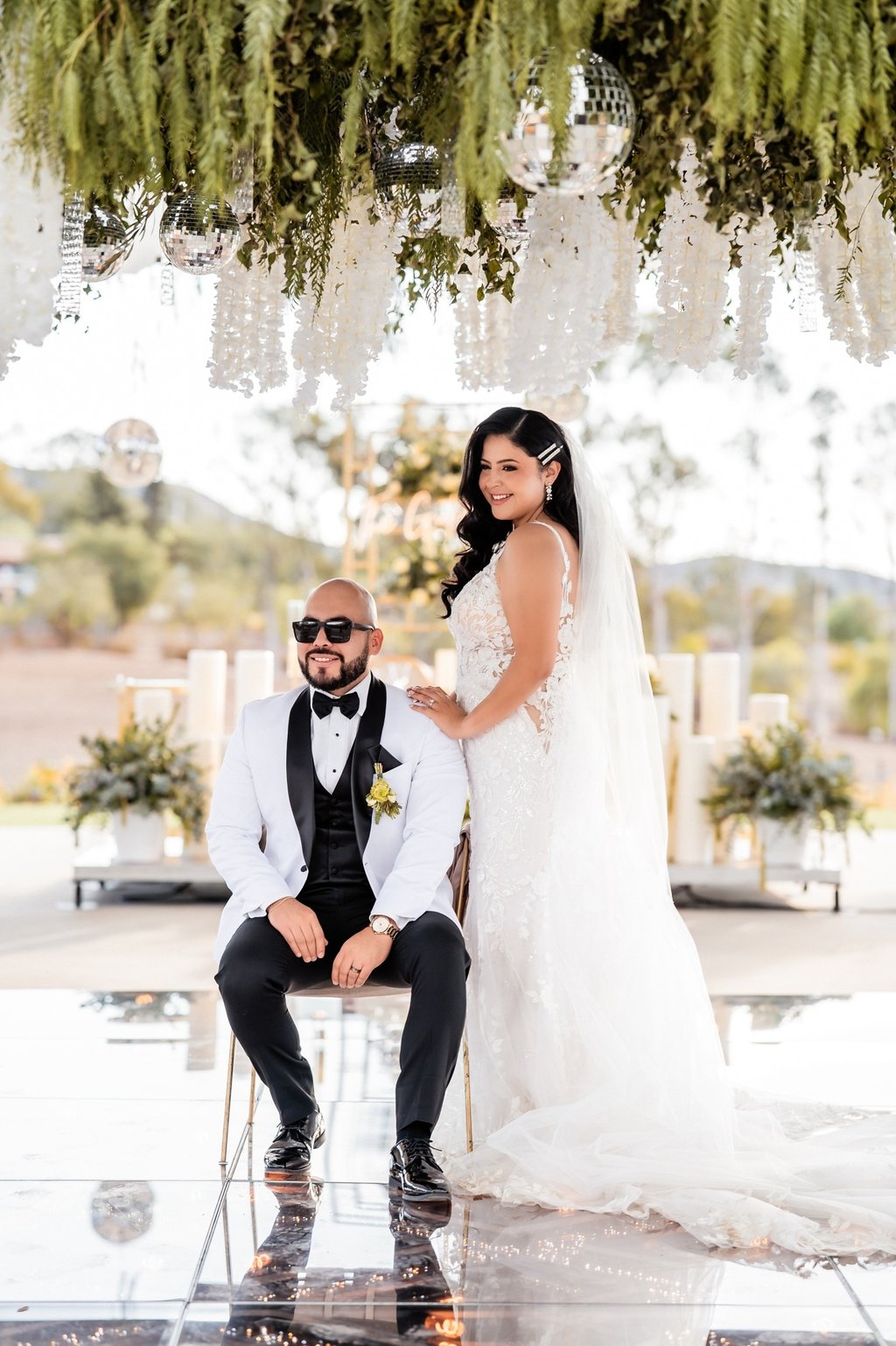 a bride and groom sitting on a chair in a wedding ceremony