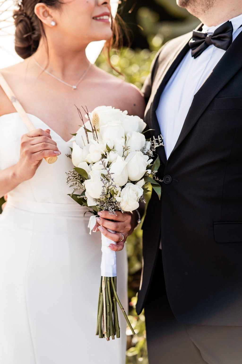 a bride and groom standing next to each other