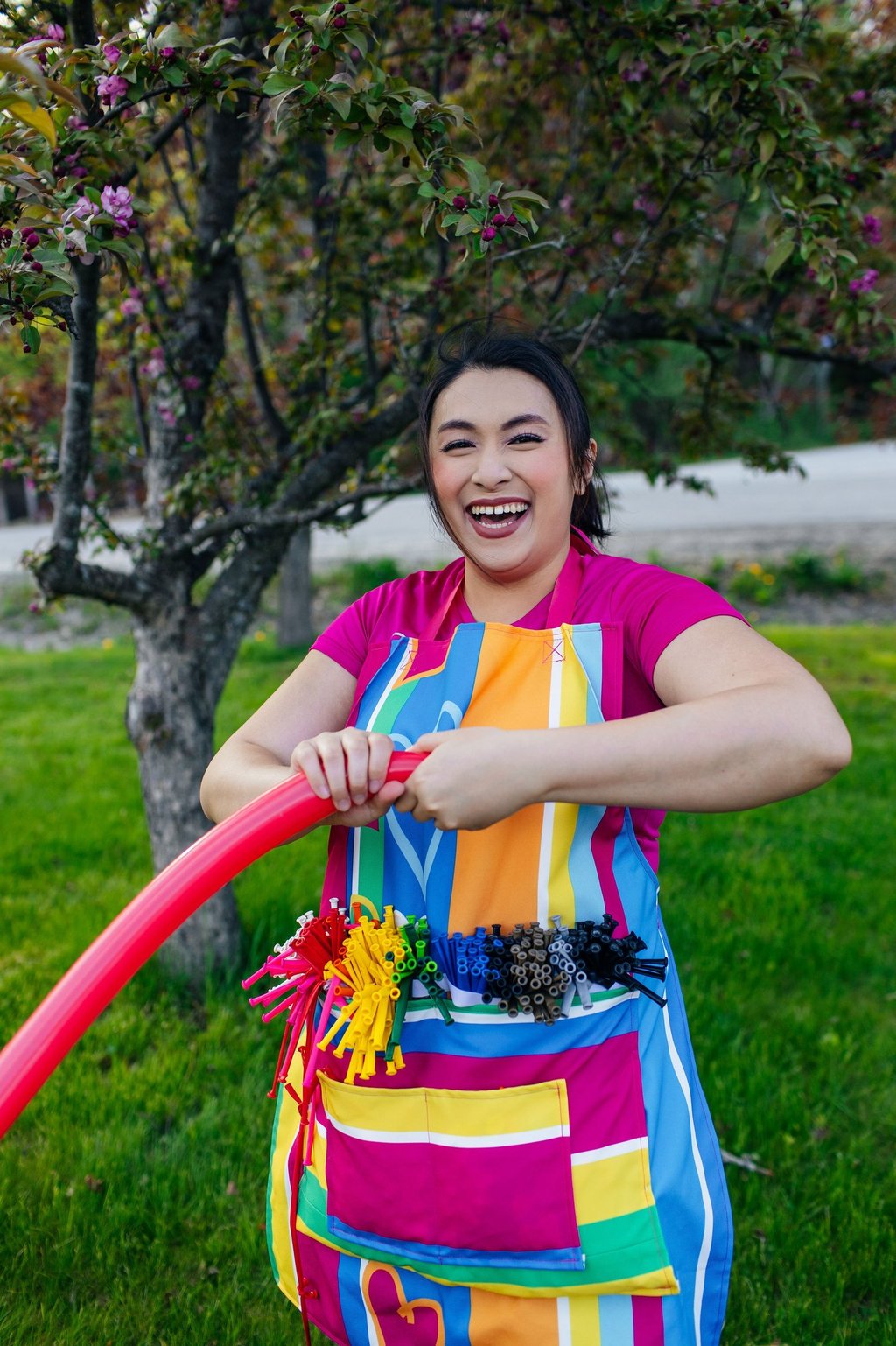 A balloon twister smiling for a photo