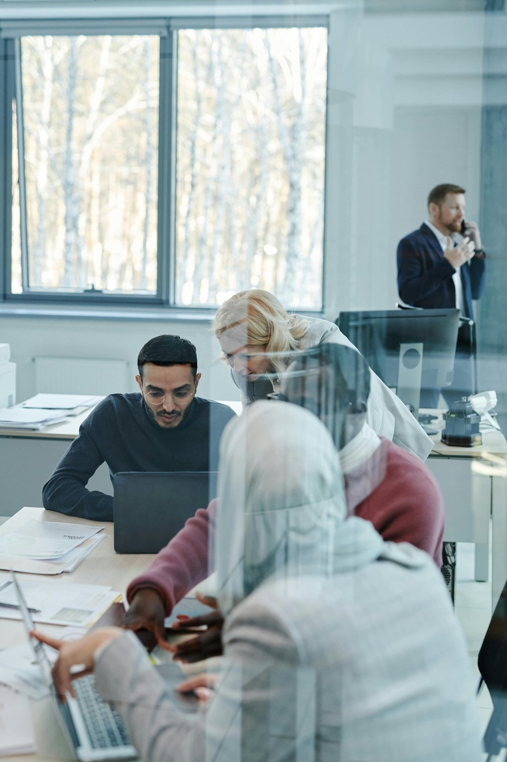 Professionals looking at data in a laptop
