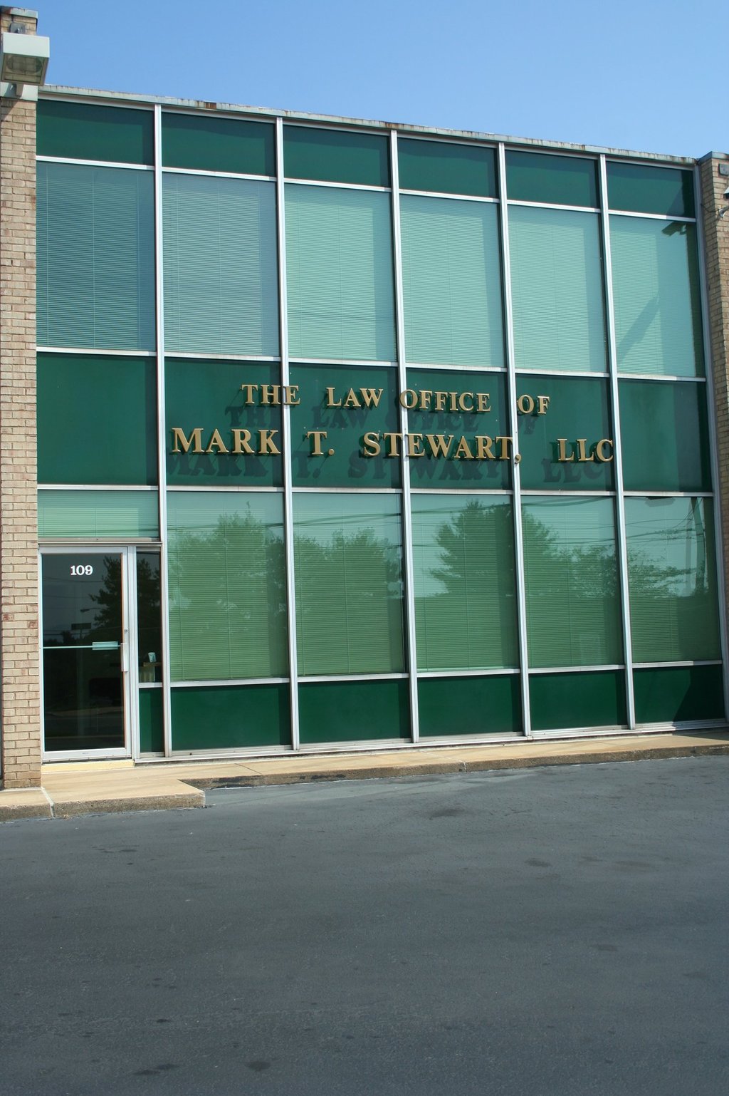 a building with a sign that says the law office of Mark T. Stewart