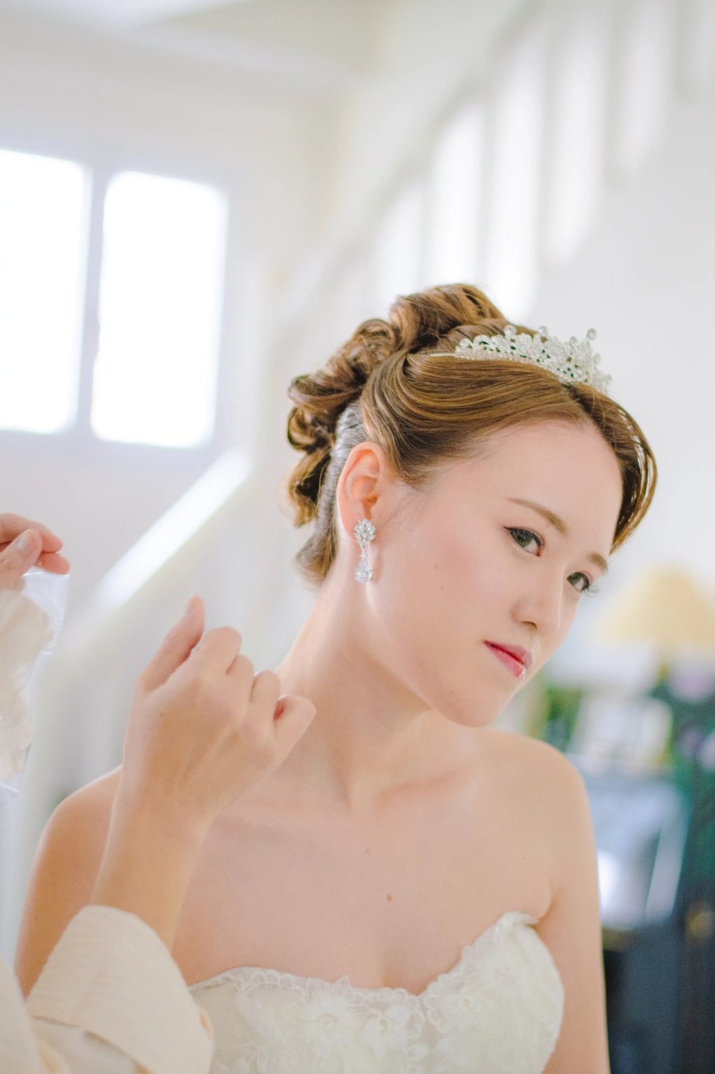 a woman in a wedding dress is wearing a tiablet