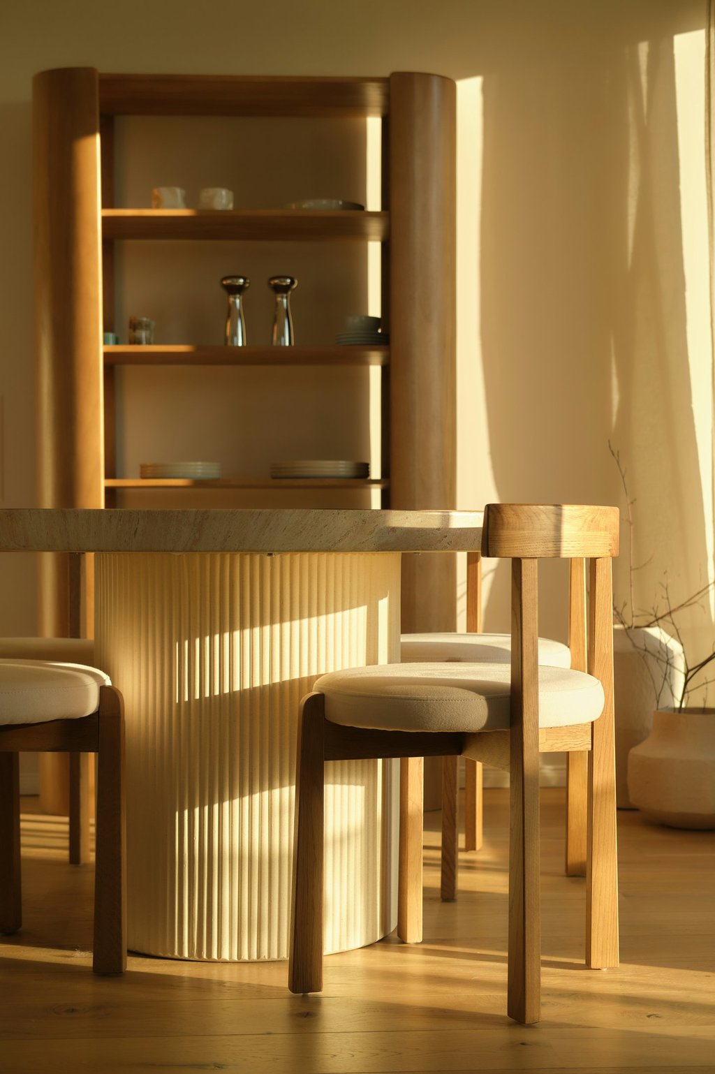 Modern organic interior design showcasing natural wood textures and bespoke fluted timber furniture.