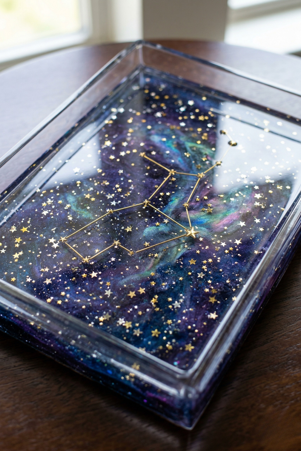 Handmade epoxy resin tray featuring a galaxy nebula design with gold constellation and star glitters.