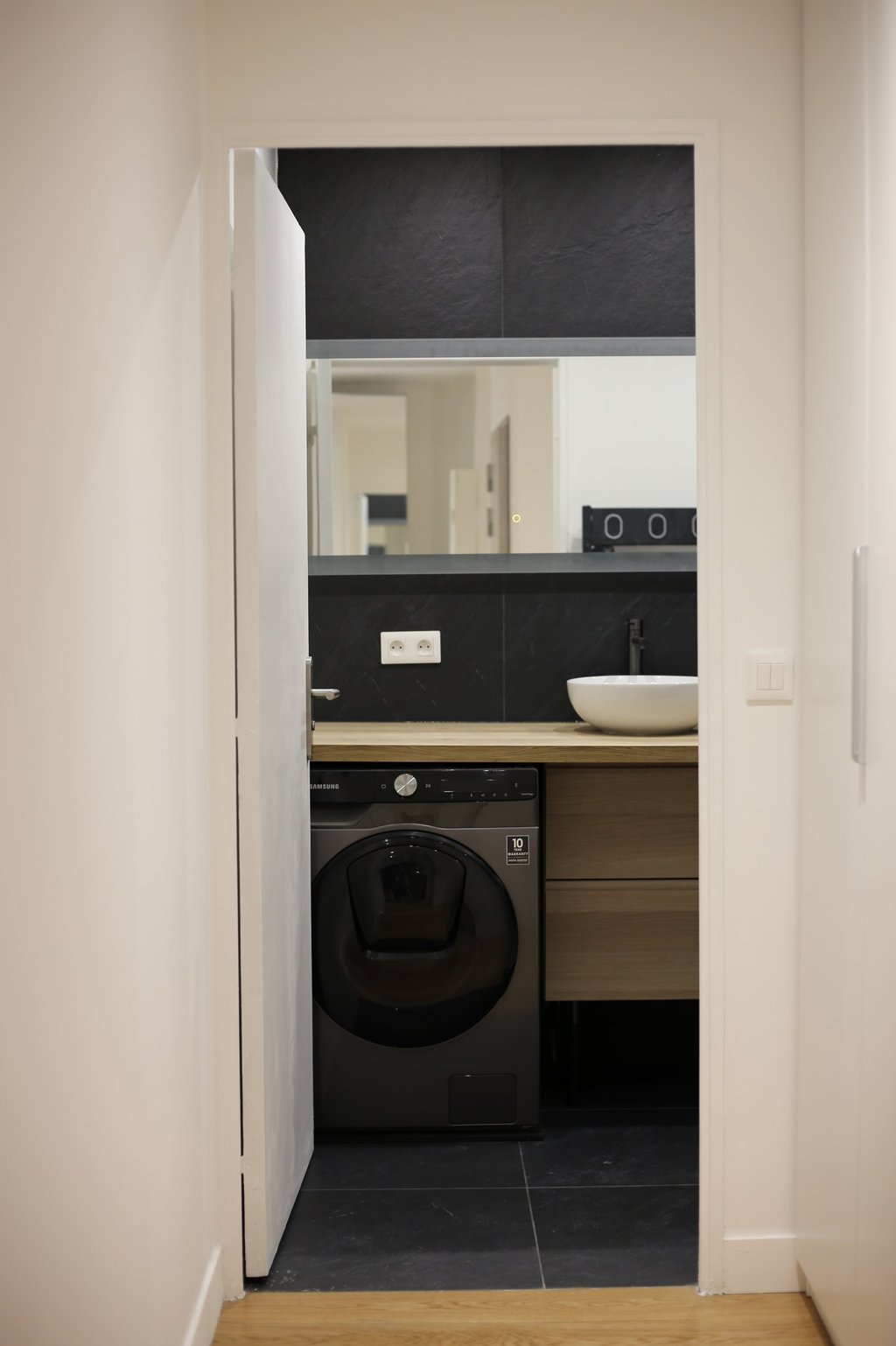 a washer in a bathroom with a sink and a washer