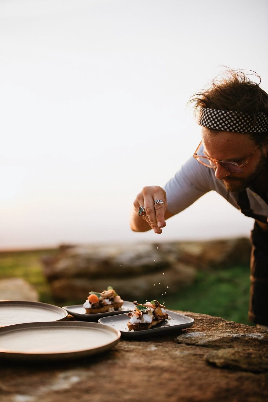 a man is sprinkling food on a table