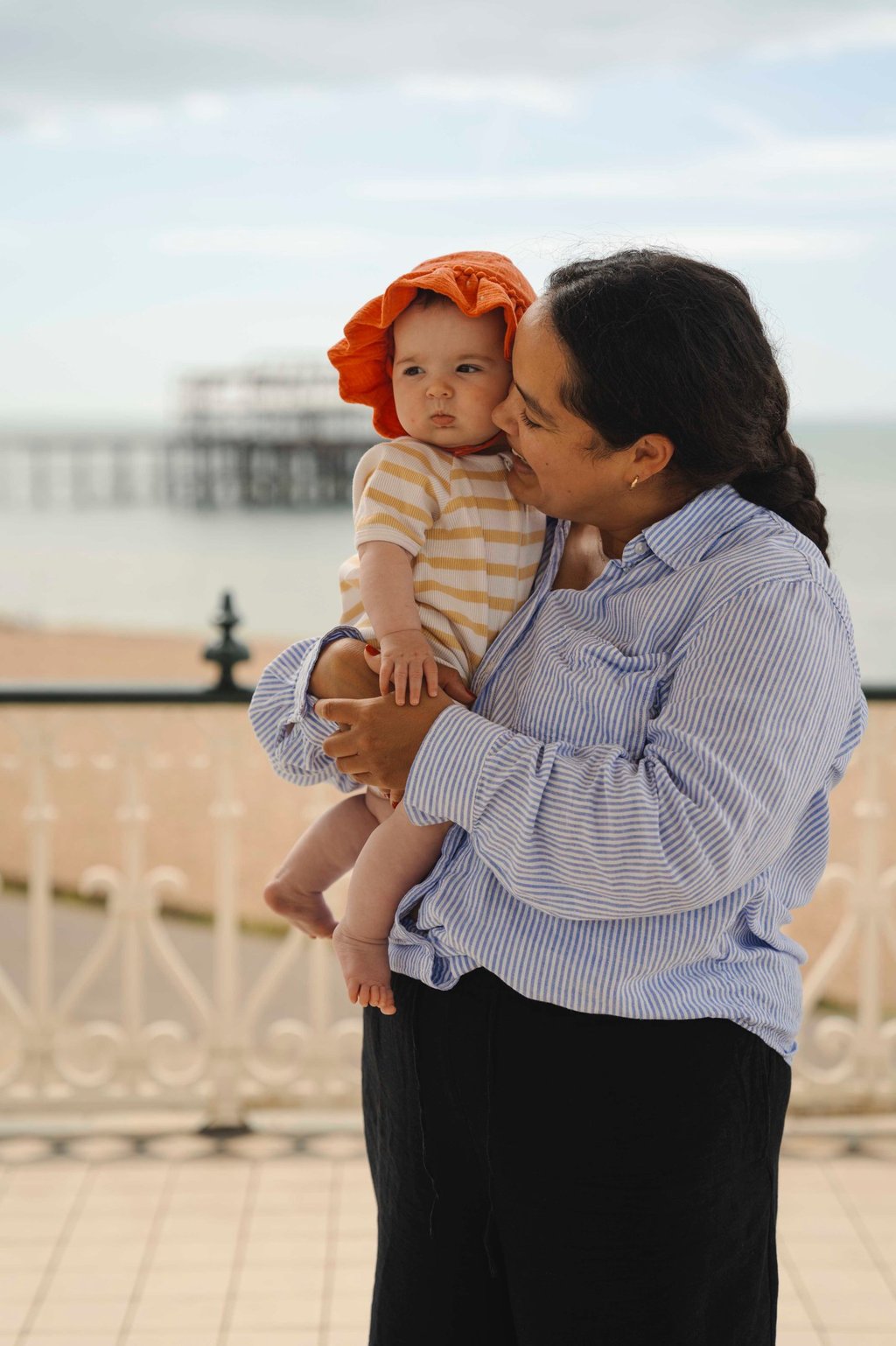 Mother holding her baby on the arms and smiling