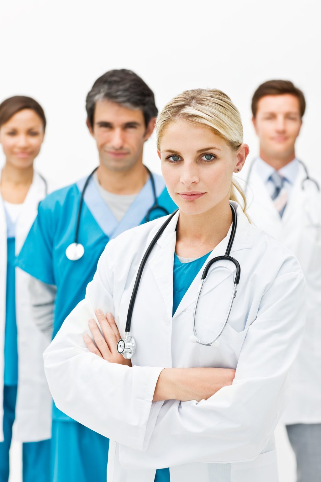 A diverse team of medical doctors and healthcare professionals in white coats and scrubs with stethoscopes.
