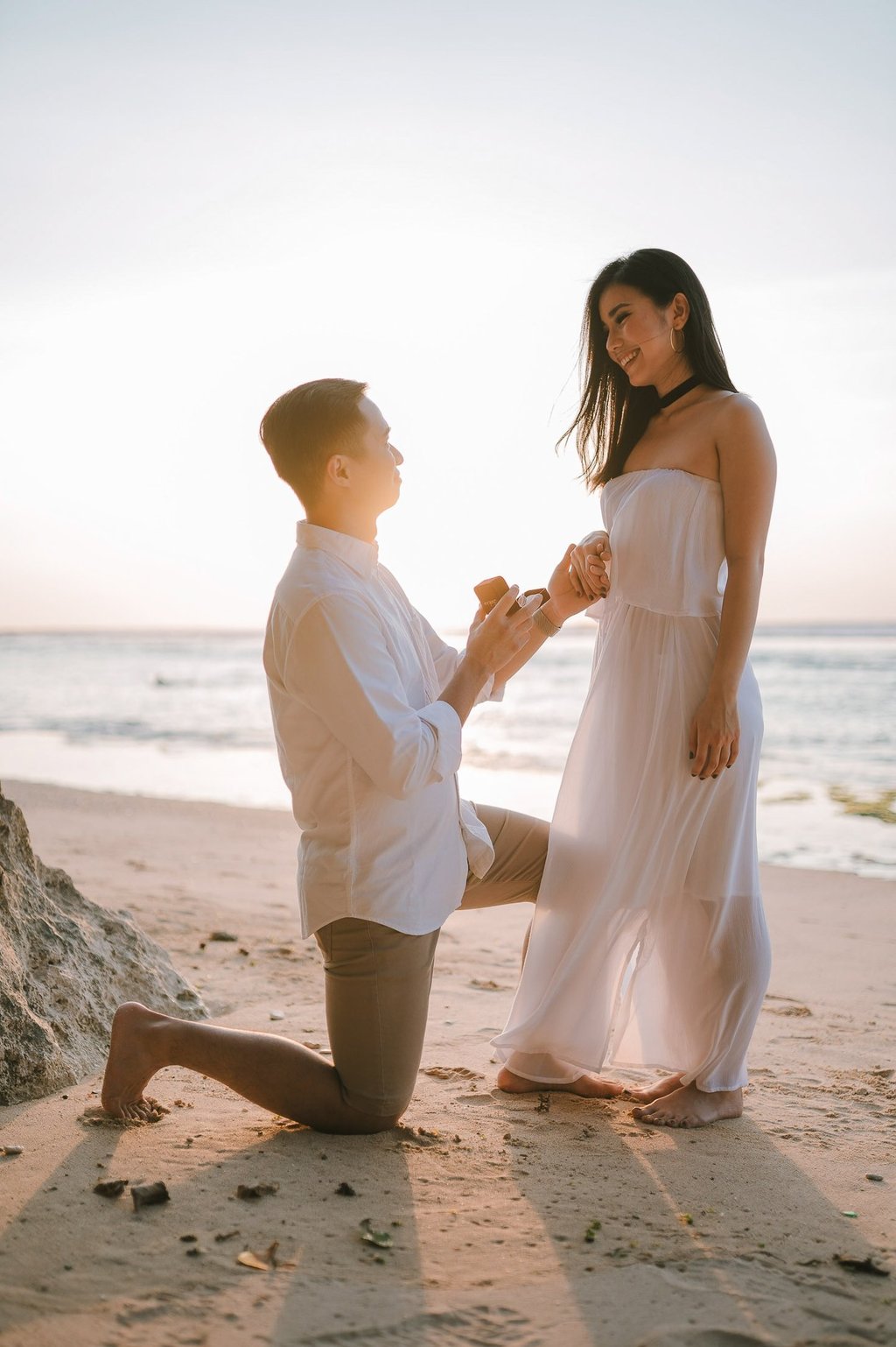 Beach proposal moment during a couple photography session at Anantara Uluwatu Bali Resort.