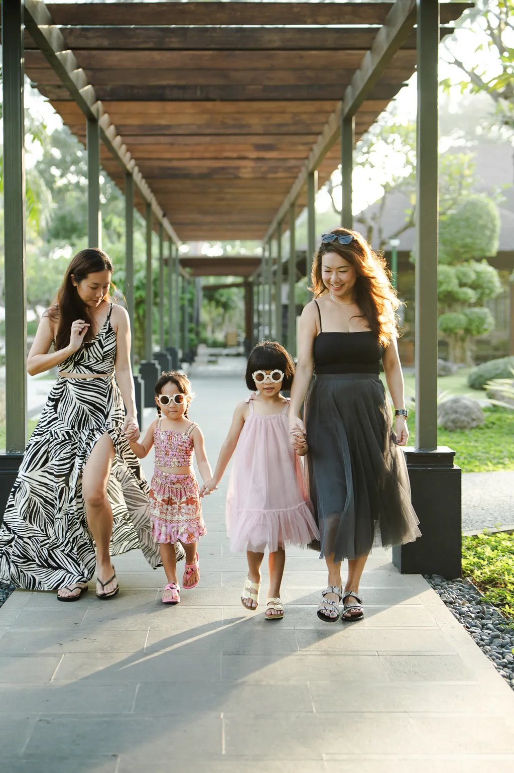 Family walking together at Padma Resort Legian Bali during natural and relaxed lifestyle photography session.