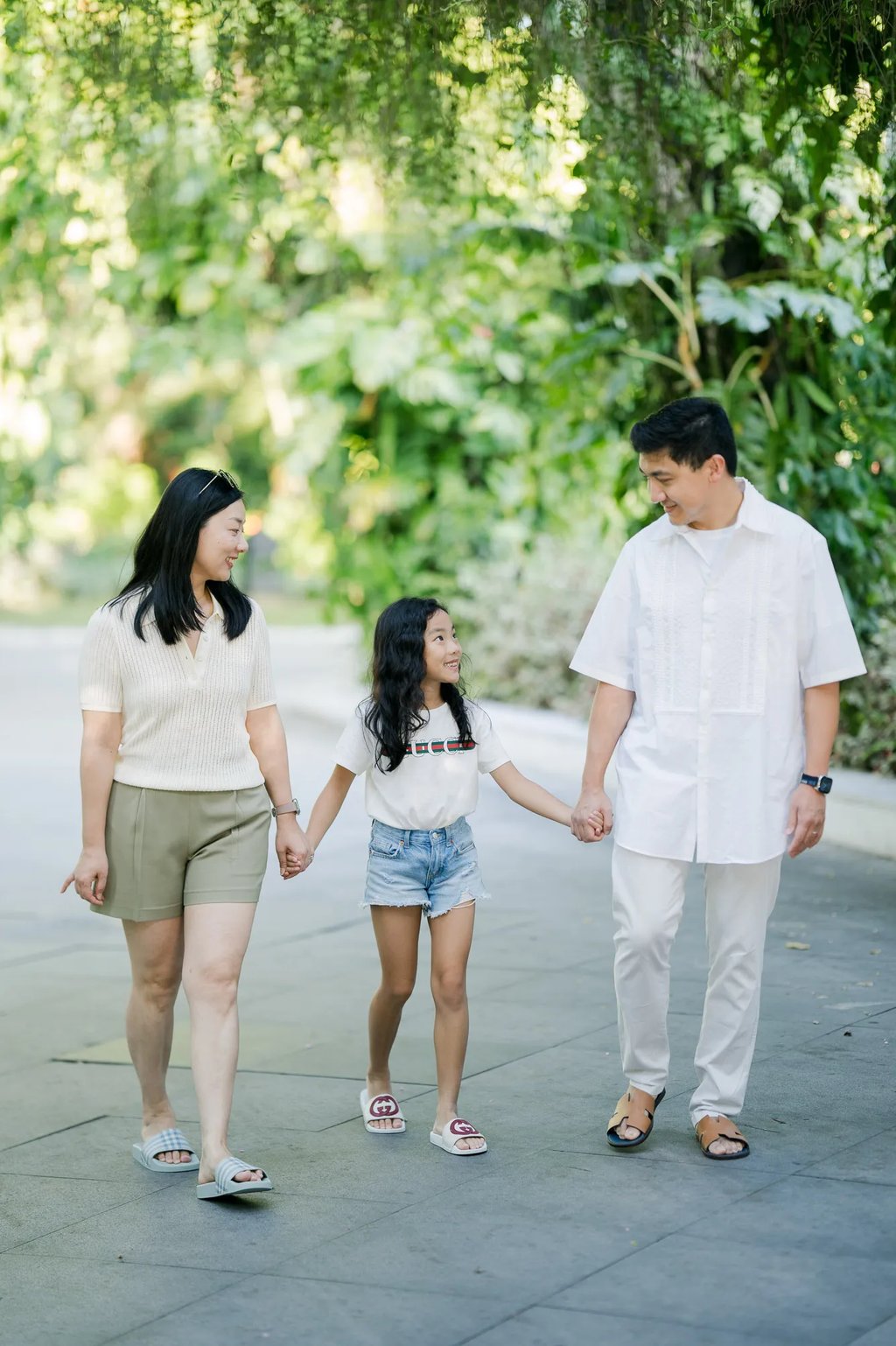 Family walking hand in hand along a resort pathway at InterContinental Bali Resort Bali