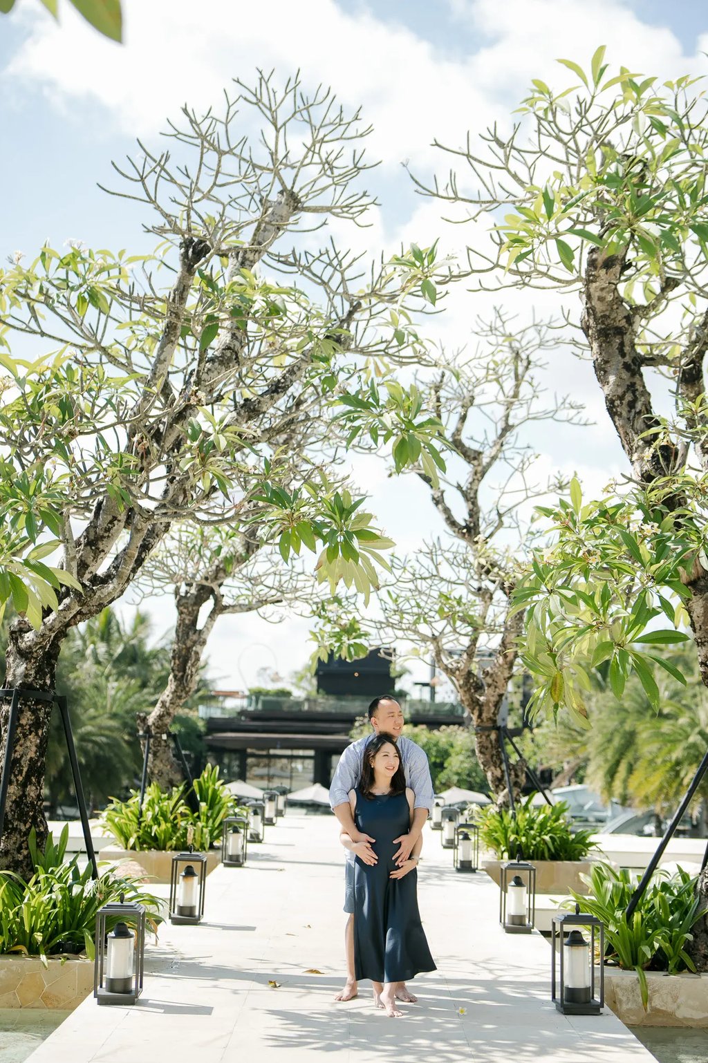 Couple photography session along the tropical garden walkway at The Apurva Kempinski Bali