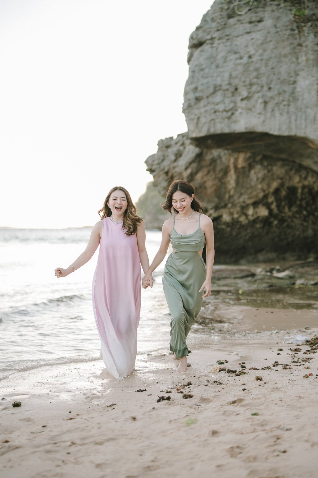 Two friends walking together along the beach during photoshoot at Geger Beach Nusa Dua Bali