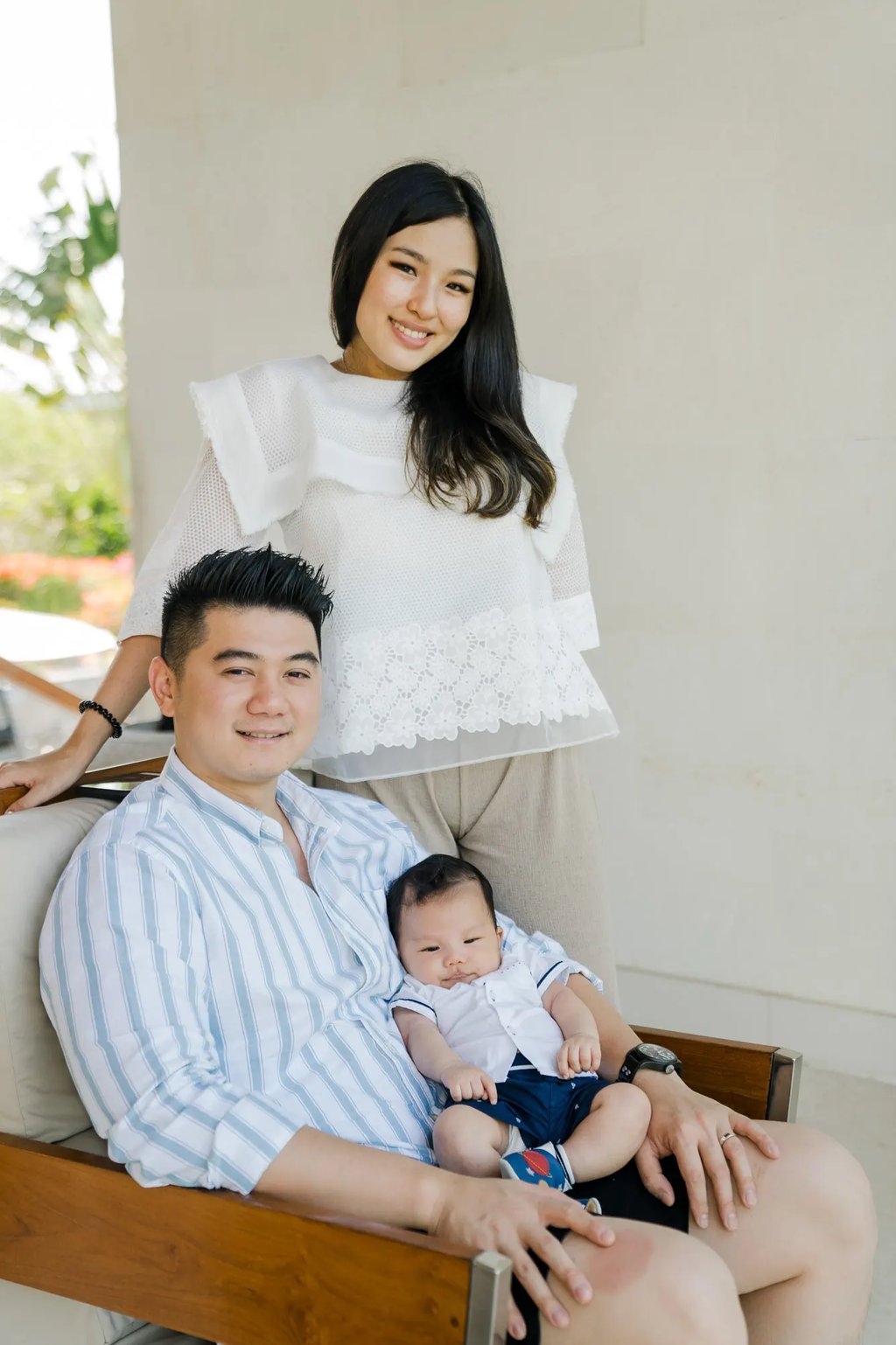 Family relaxing together inside their suite at Samabe Bali Suites & Villas in Nusa Dua.